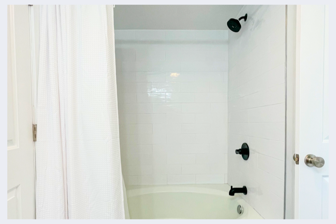Your private bathroom features a clean tub-shower combo with modern fixtures, perfect for unwinding after your adventures.