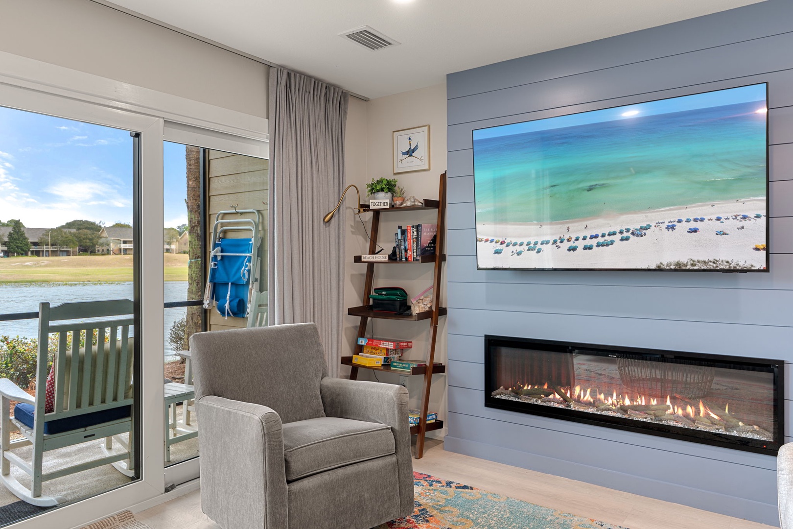 Unwind in your cozy living space with a crackling fireplace and peaceful water views from your private balcony.