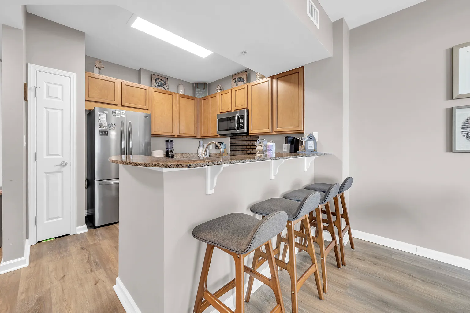 Your fully equipped kitchen features granite counters, stainless appliances, and a breakfast bar perfect for morning coffee or casual dining.