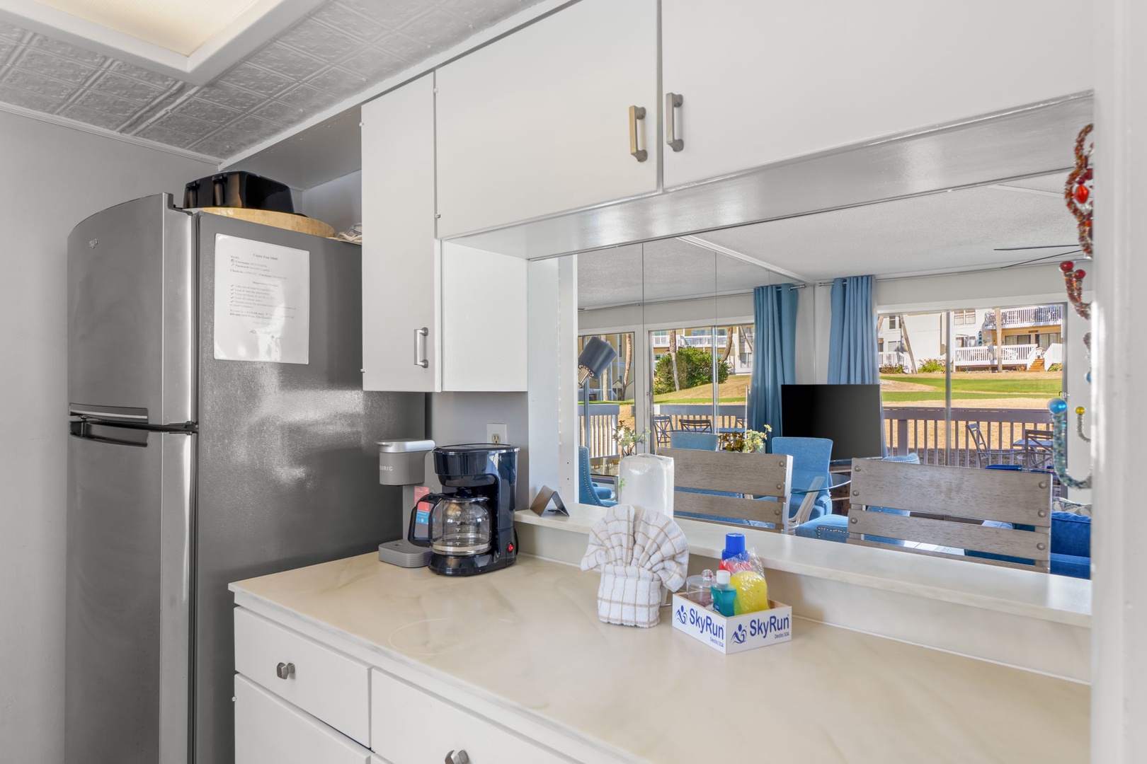 Enjoy the kitchen coffee station and open pass-through design connecting the kitchen to the living area. A bright, welcoming space perfect for morning coffee, casual meals, and easy gathering throughout your stay.