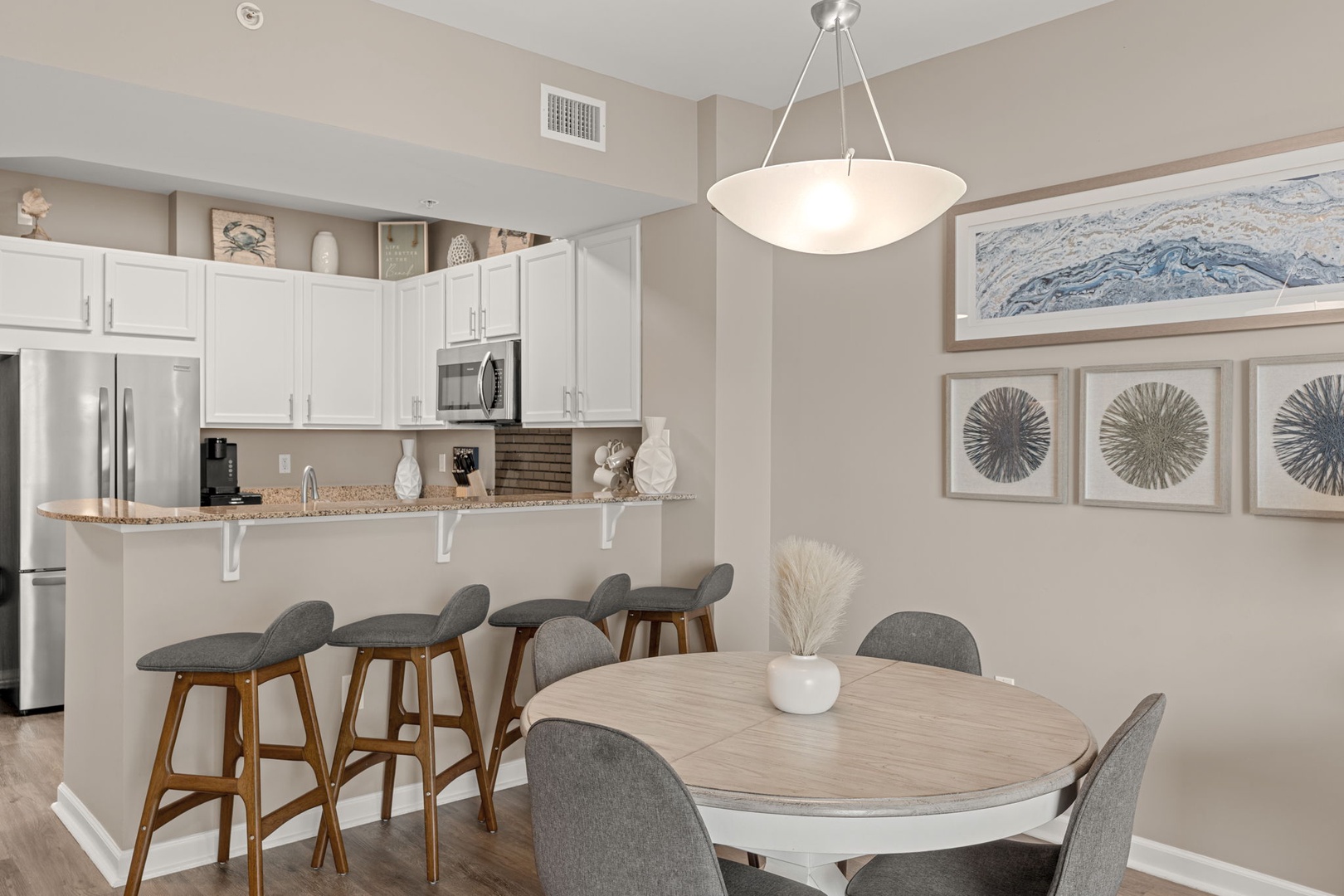 Gather around your open-concept kitchen and dining area, perfect for morning coffee or evening meals with loved ones in a bright, inviting space.