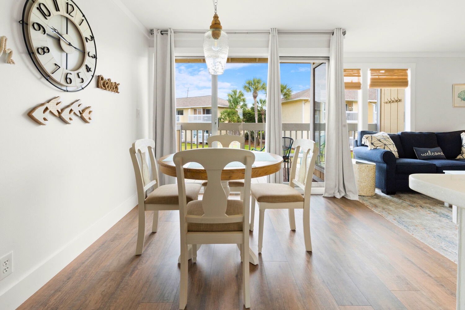 Gather around your bright dining table where morning coffee meets ocean breezes through sliding doors to your private balcony.