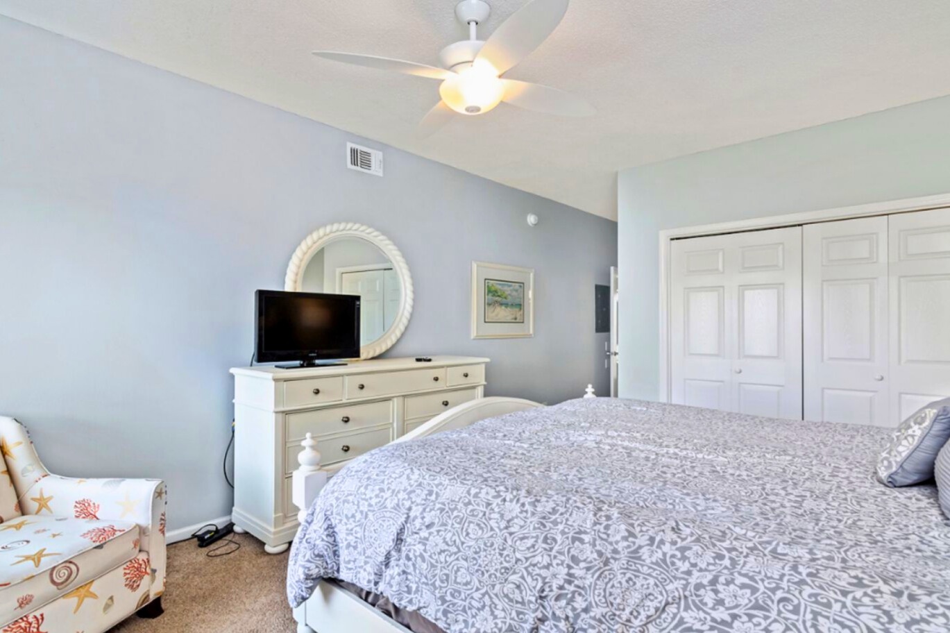 Drift into peaceful dreams in your serene bedroom with soft linens, gentle ceiling fan, and calming coastal colors creating the perfect retreat.