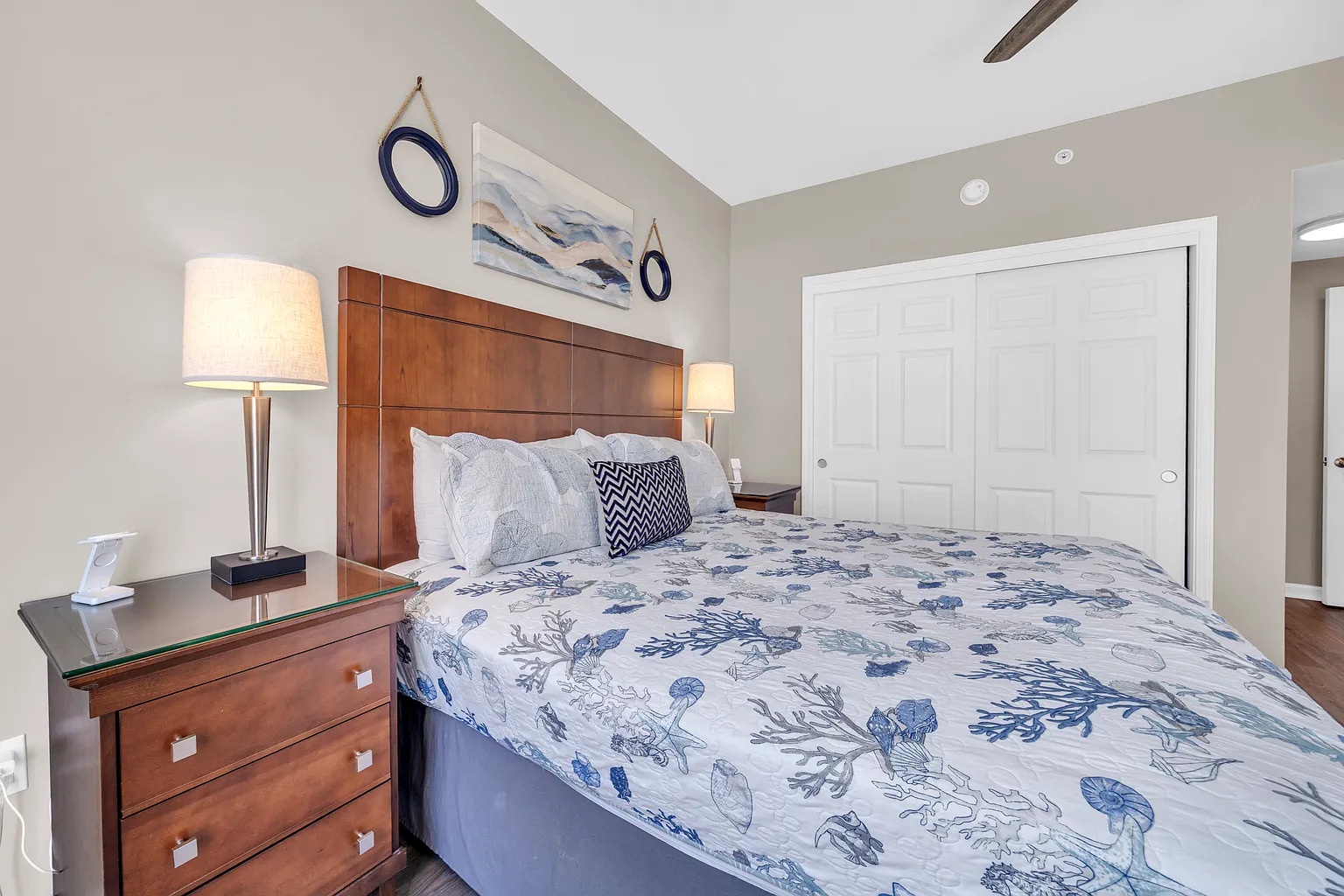 Drift off in your coastal-themed bedroom with nautical bedding and warm lighting that sets the mood for relaxation.