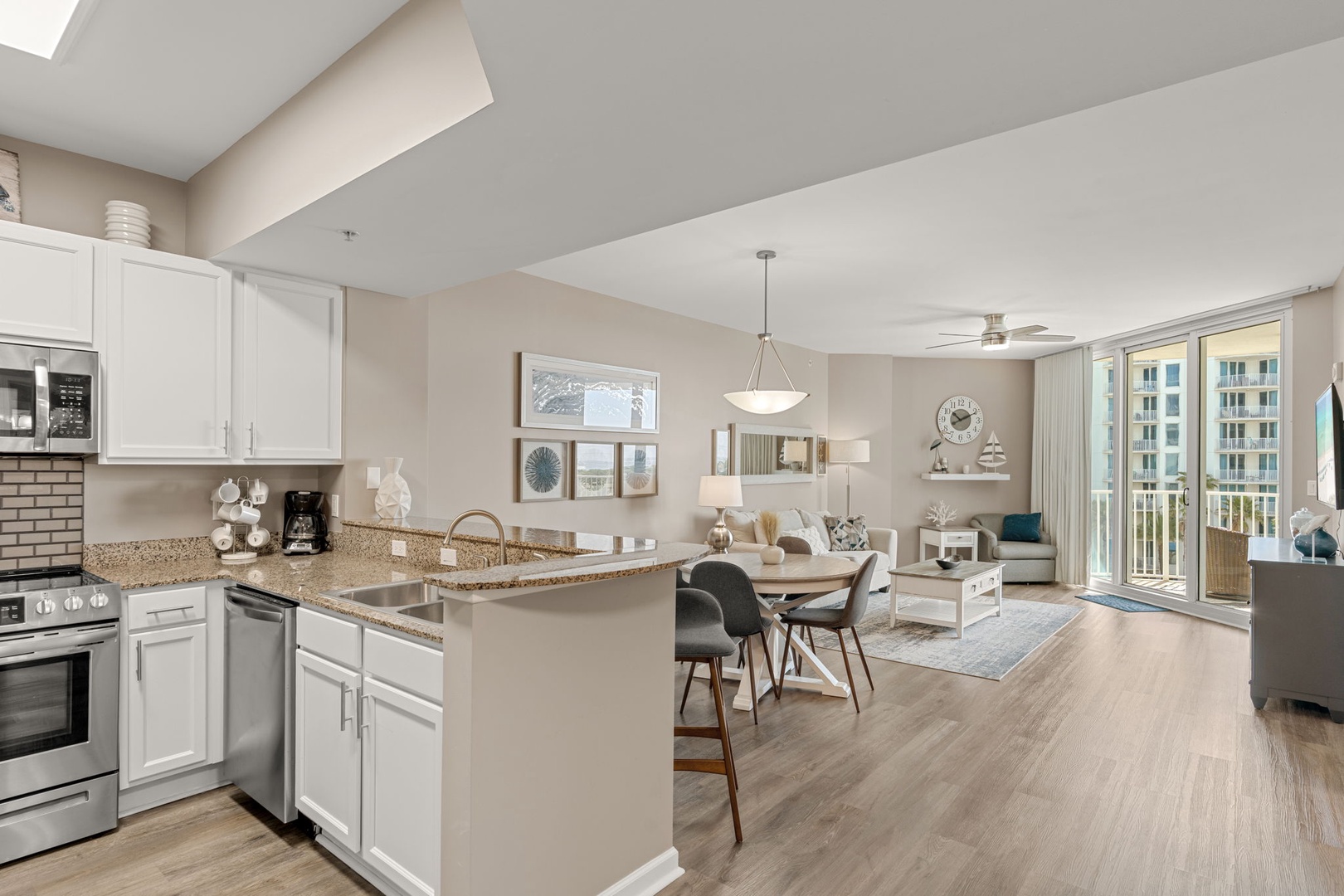 Step into your spacious open-concept living area where natural light pours through sliding glass doors onto warm wood floors. Enjoy preparing meals in your fully equipped kitchen with modern appliances and granite countertops.