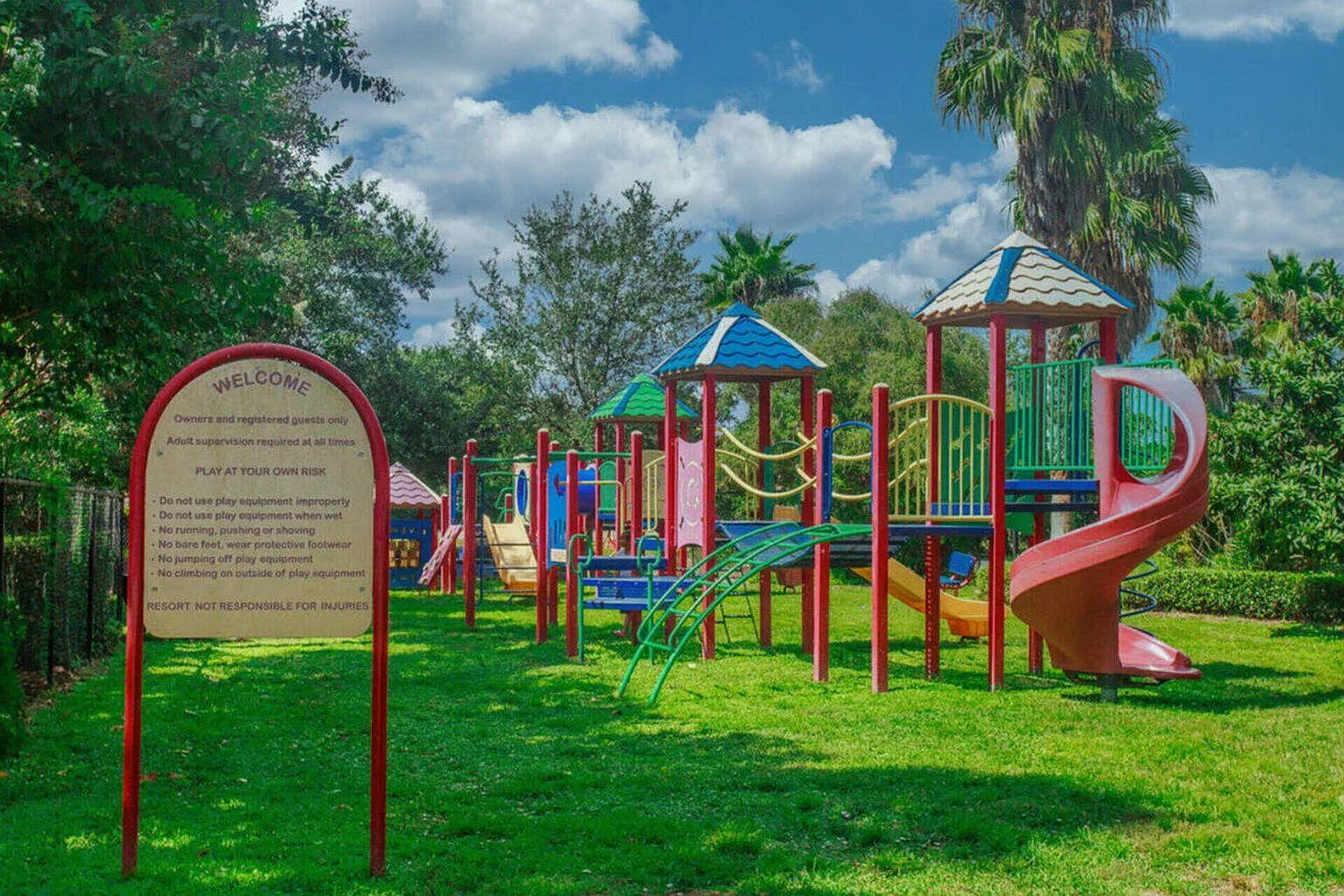Colorful playground surrounded by tropical gardens offers endless fun for young adventurers during their stay.
