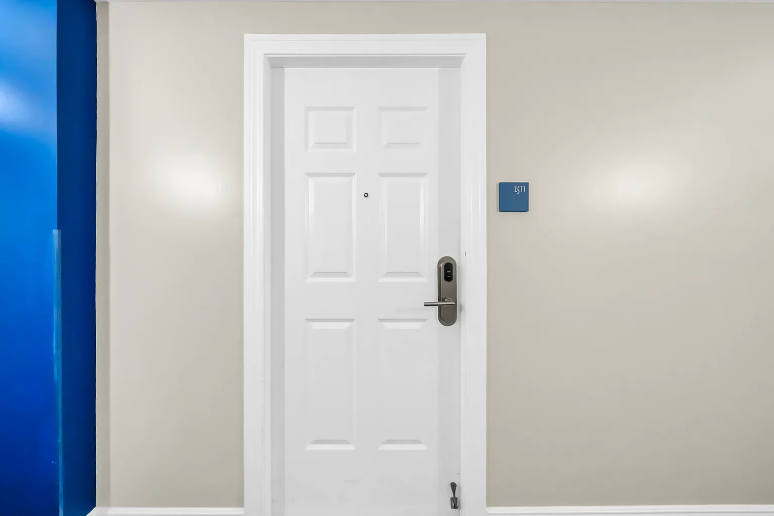 Clean, modern entry with secure keyless access and bright blue accents welcomes you to your comfortable retreat.