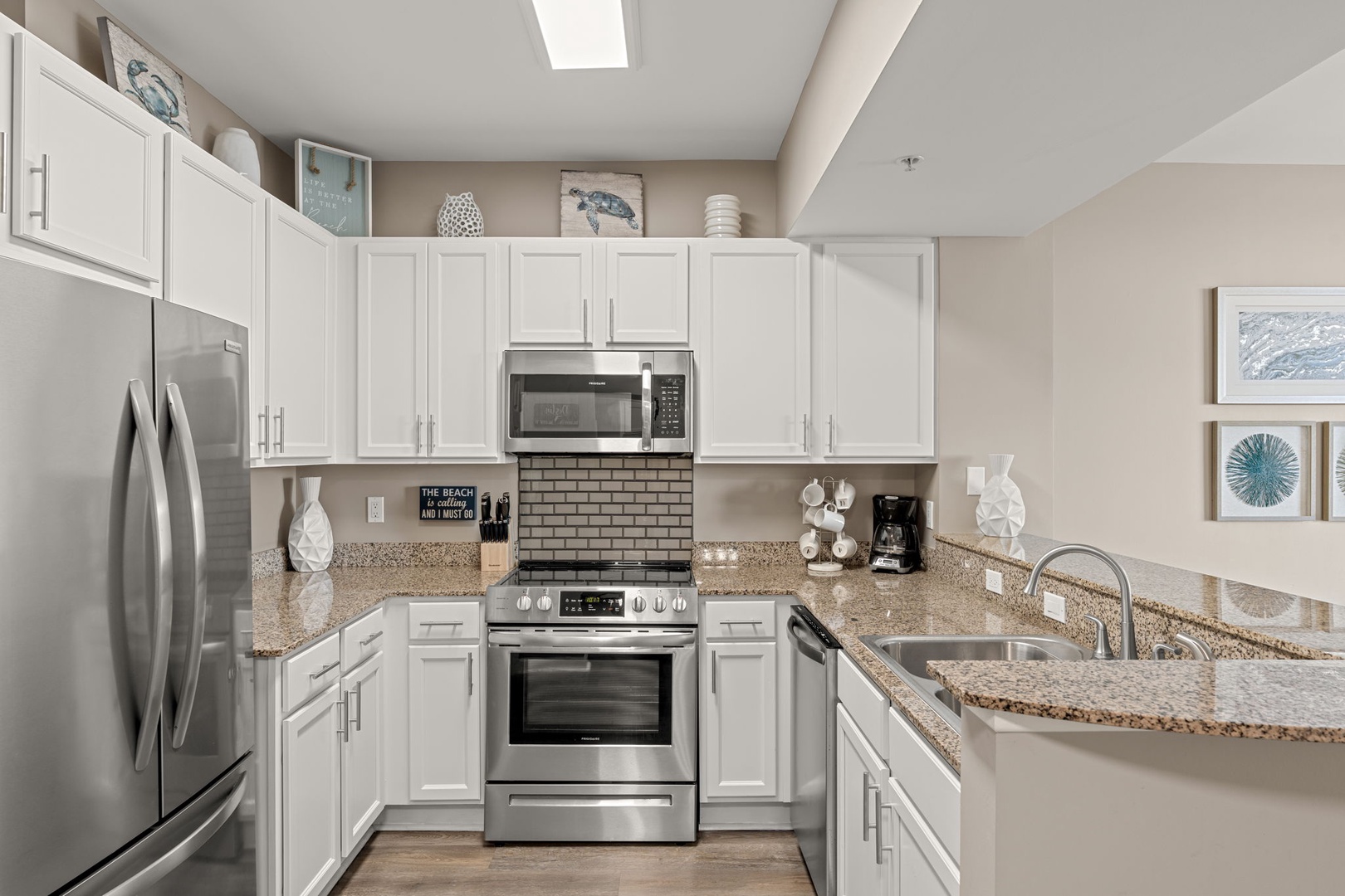 Your fully equipped kitchen features stainless steel appliances, granite countertops, and coastal-inspired décor, perfect for whipping up delicious meals during your beach getaway.