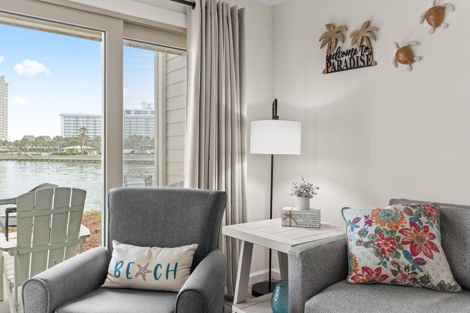 Settle into your waterfront paradise with coastal charm and stunning lake views from your cozy seating area.