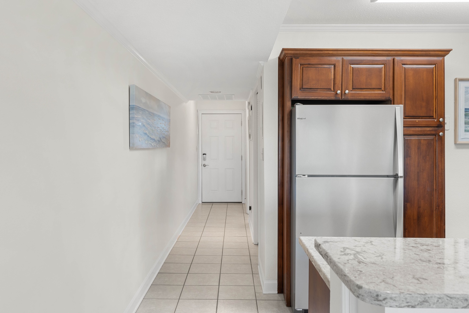 Your sleek kitchen features premium stainless steel appliances and rich wood cabinetry, with marble countertops perfect for meal prep.