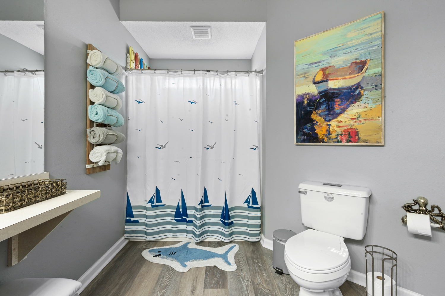 Freshen up in your coastal-themed bathroom, complete with nautical artwork and soft towels ready for your comfort.