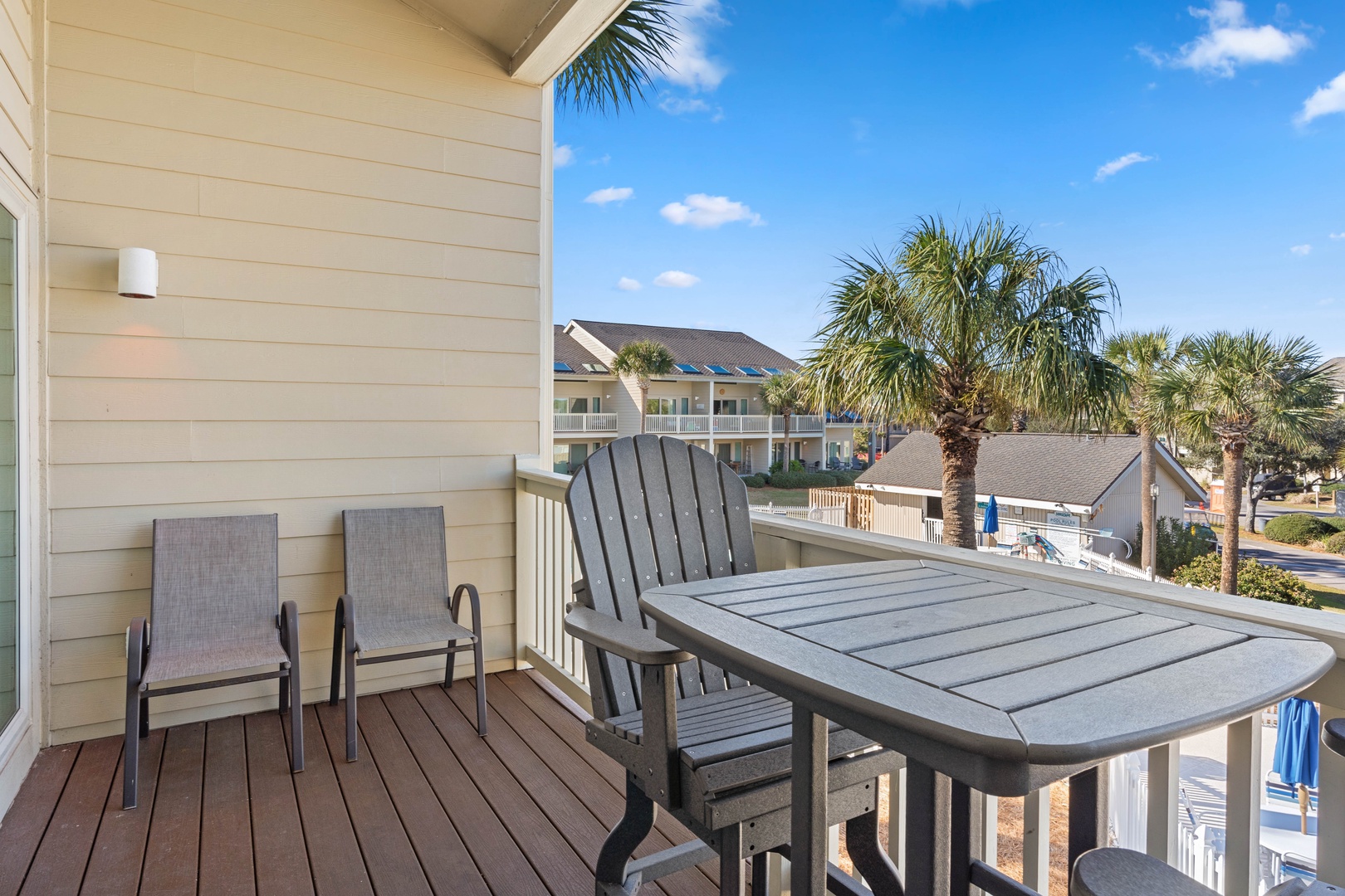 Unwind on your private balcony with comfortable seating and dining table, perfect for morning coffee or evening meals while enjoying tropical views.