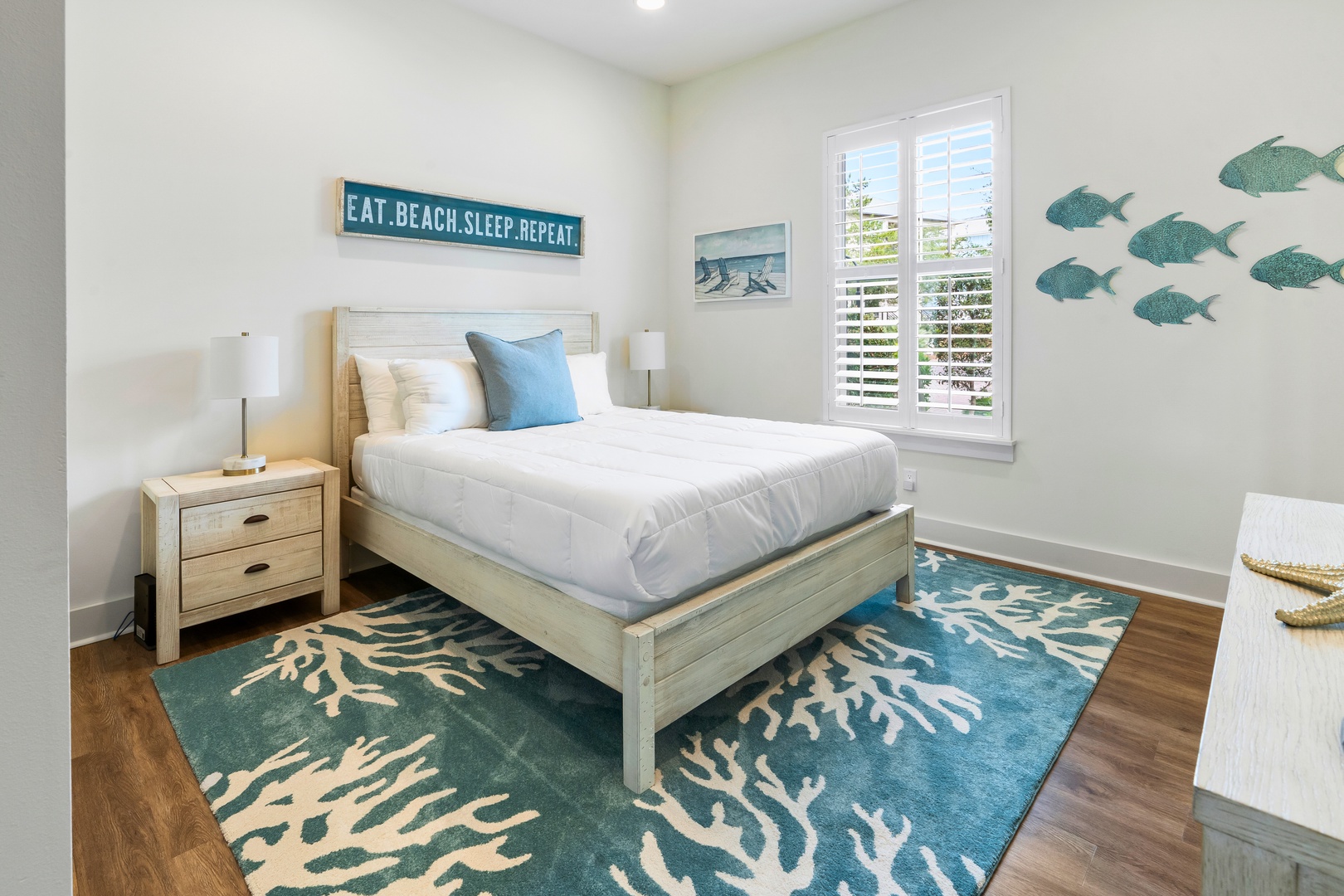 Drift off to coastal dreams in this ocean-themed bedroom where soft blues meet crisp whites for your perfect beach retreat.