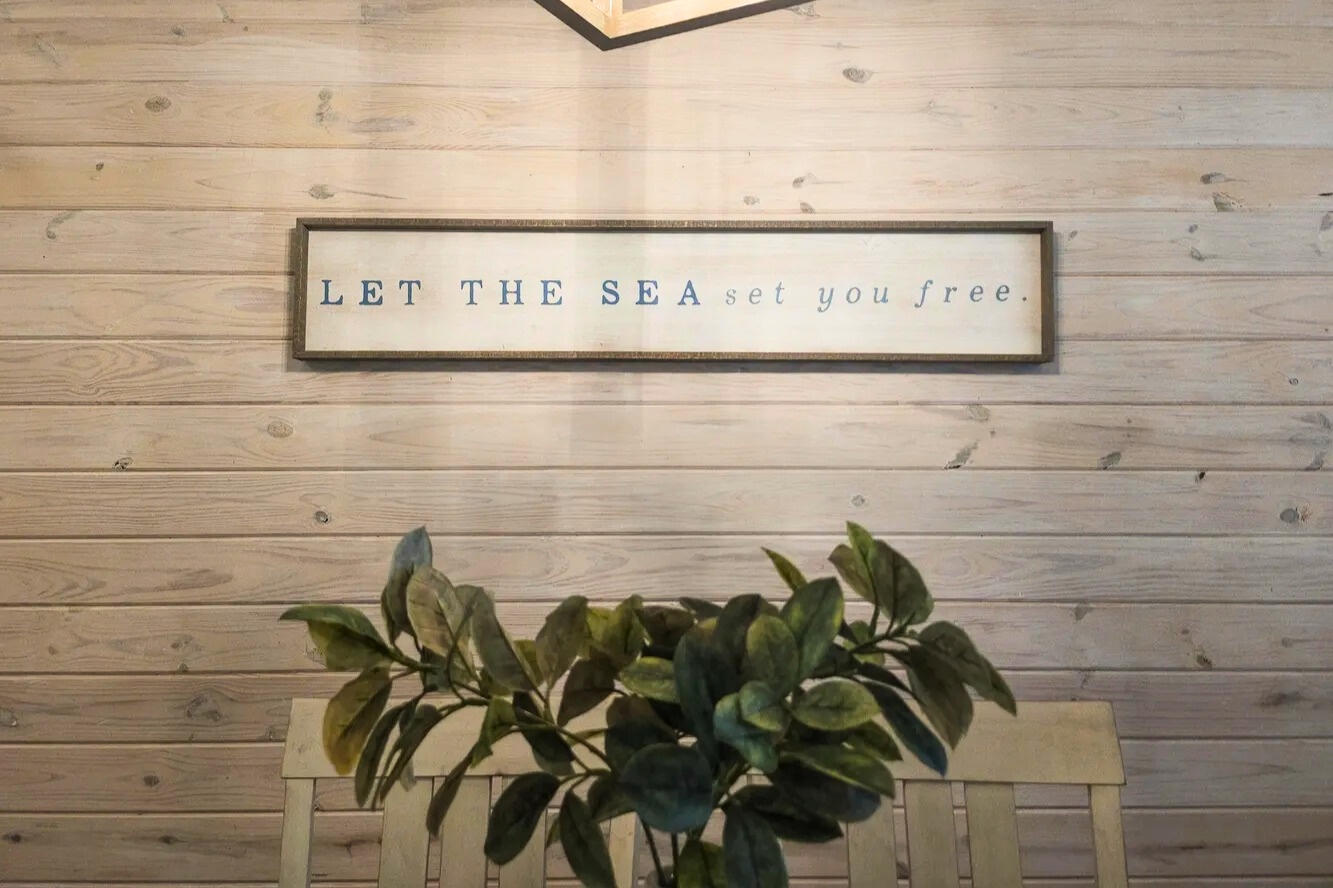 Coastal touches welcome you inside, setting a relaxed beach-house vibe that invites you to unwind, slow down, and let vacation mode begin.