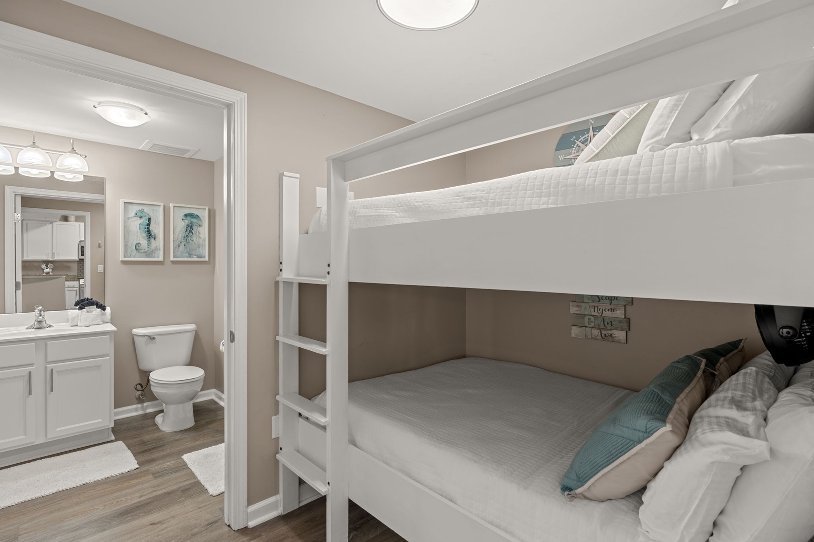 Your cozy bunk room pairs crisp white linens and soothing coastal tones with a private ensuite bathroom, perfect for restful nights and easy mornings.