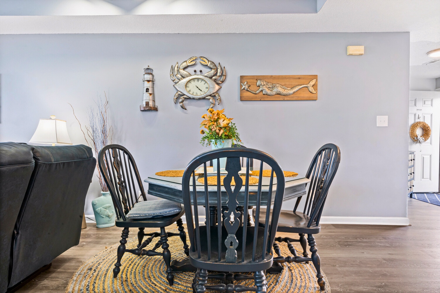 You'll love gathering around this charming coastal dining table, where nautical décor and warm touches create the perfect spot for memorable meals together.