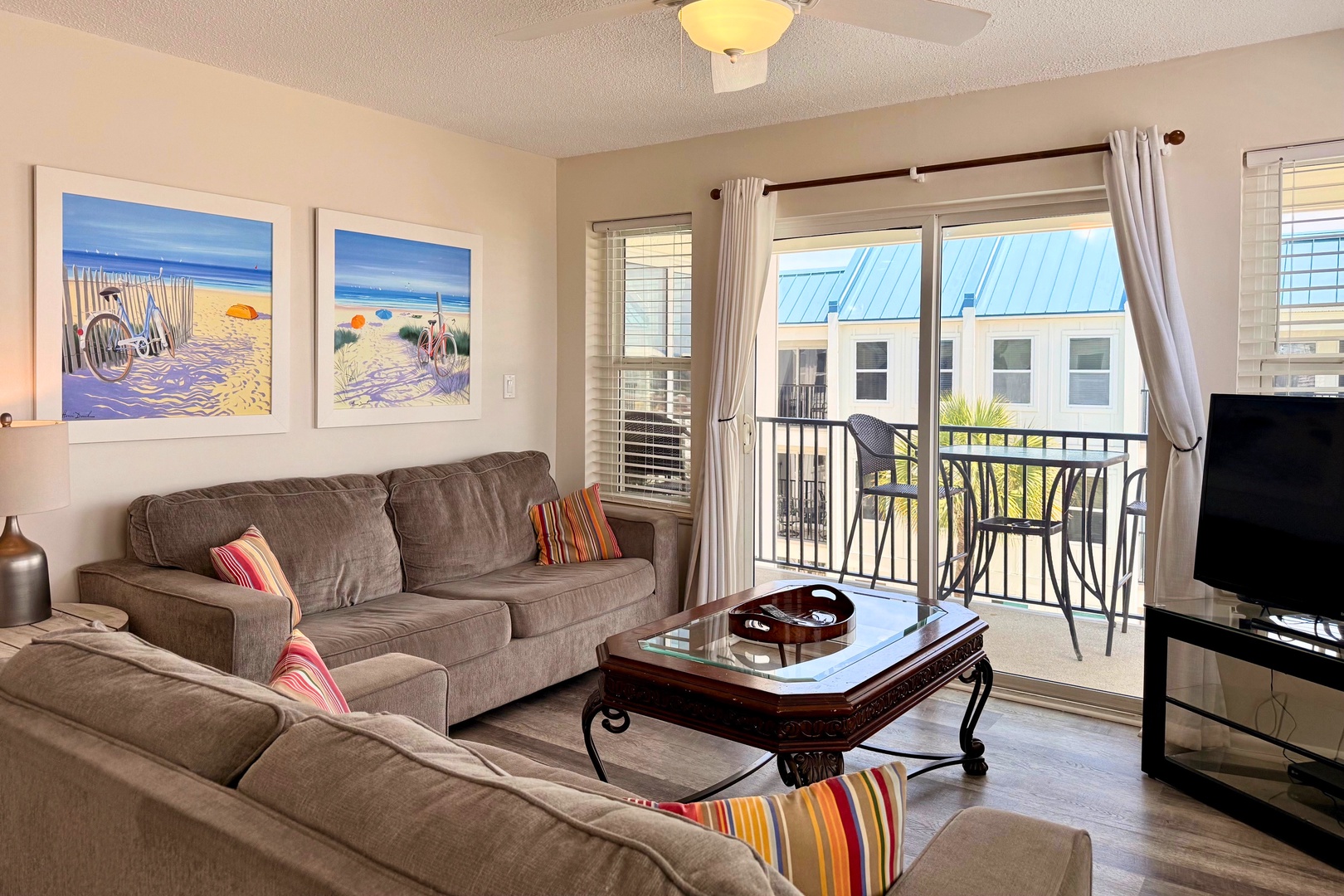 Picture yourself unwinding in this bright, comfortable living space with soft seating and coastal artwork setting a relaxed beach vibe. Your private balcony awaits for morning coffee or sunset views.
