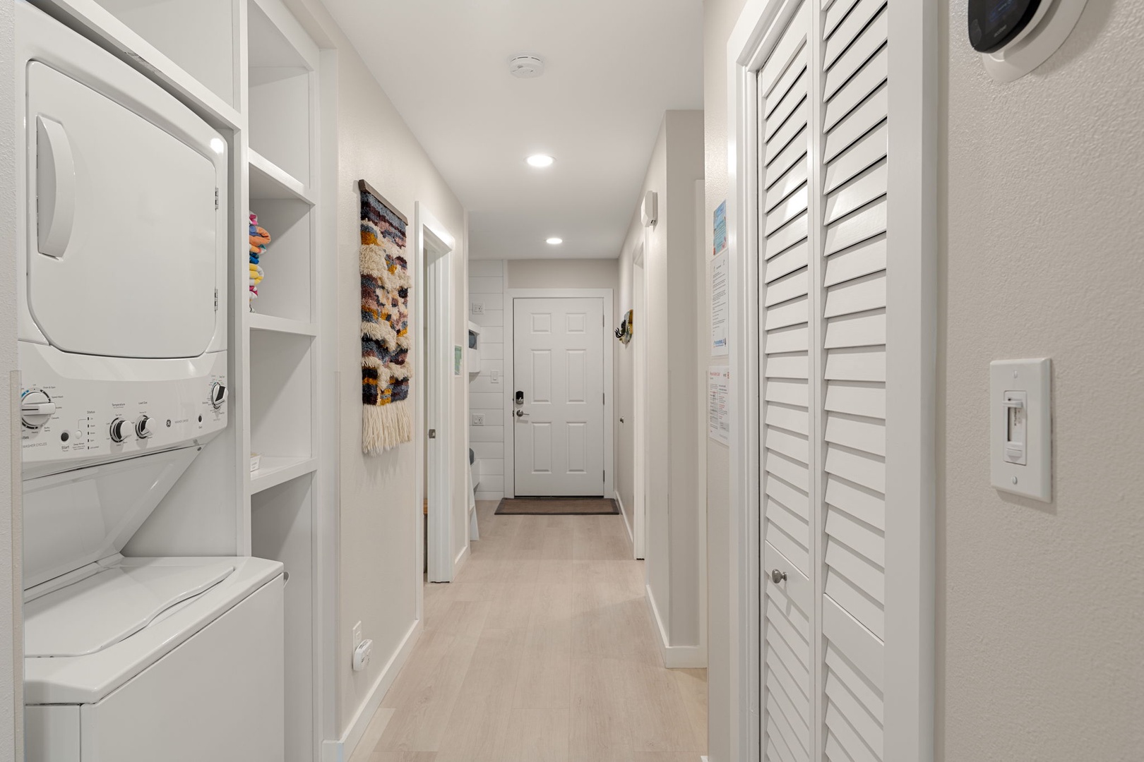 Bright entry hallway with coastal style and storage.