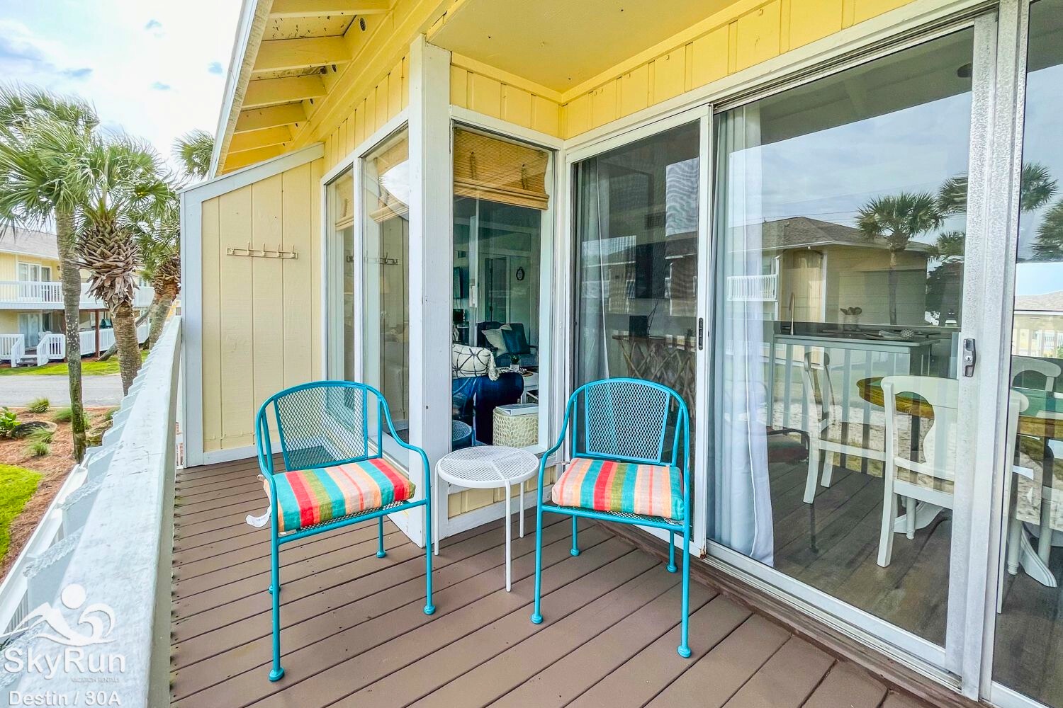 Your private deck awaits with colorful seating where you can sip morning coffee while watching palm trees sway in the coastal breeze.
