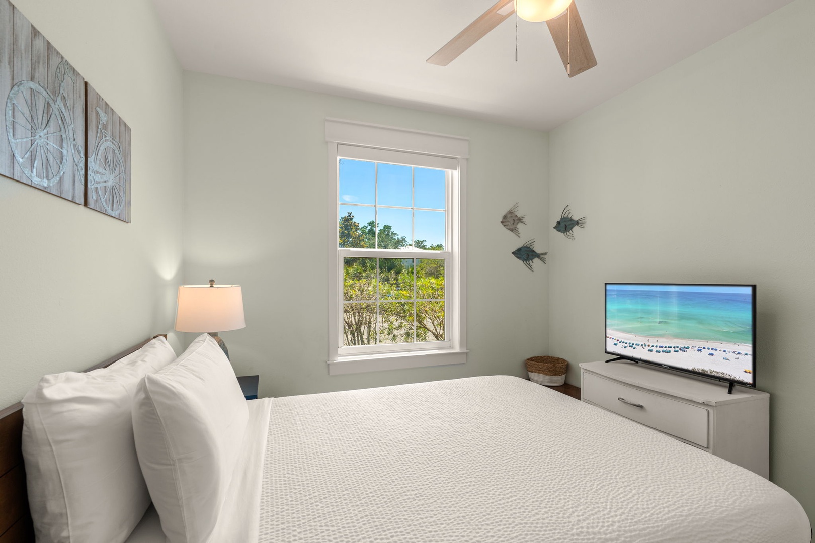 Slip into crisp linens in your serene coastal bedroom, where soft breezes and natural views greet you each morning through oversized windows, setting the tone for your perfect beach getaway.