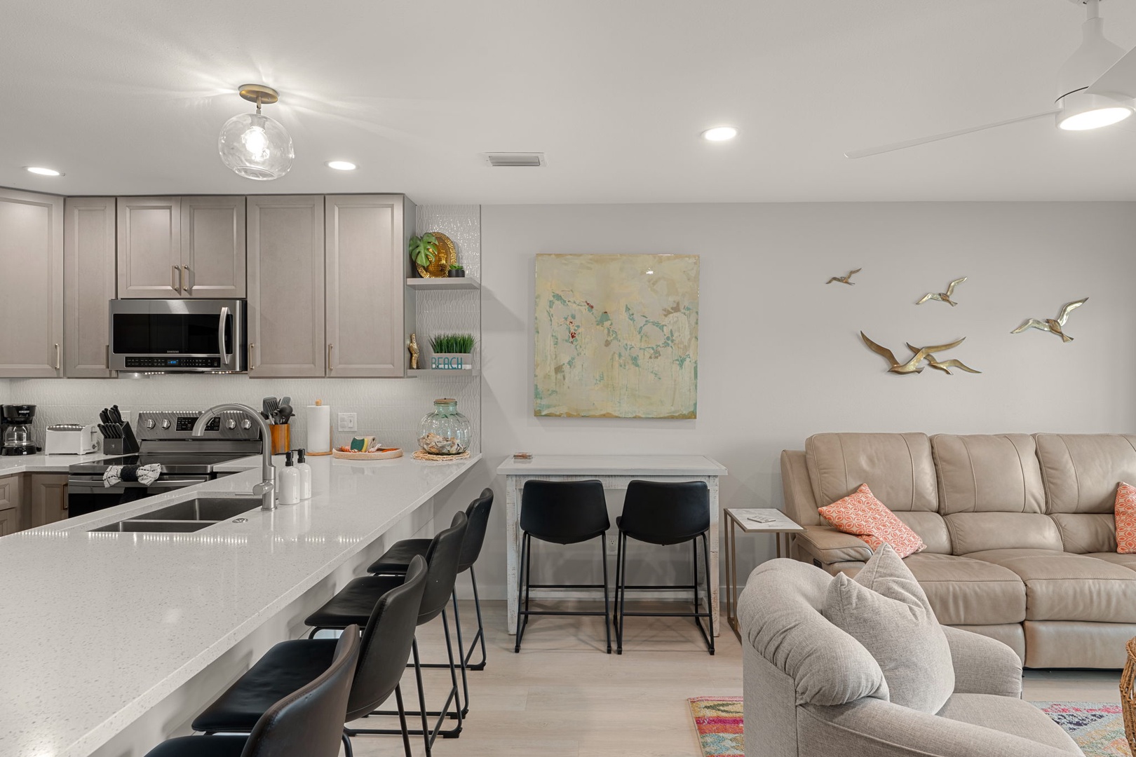 Relax in your open-concept haven where sleek kitchen meets cozy living space, perfect for cooking together and unwinding.