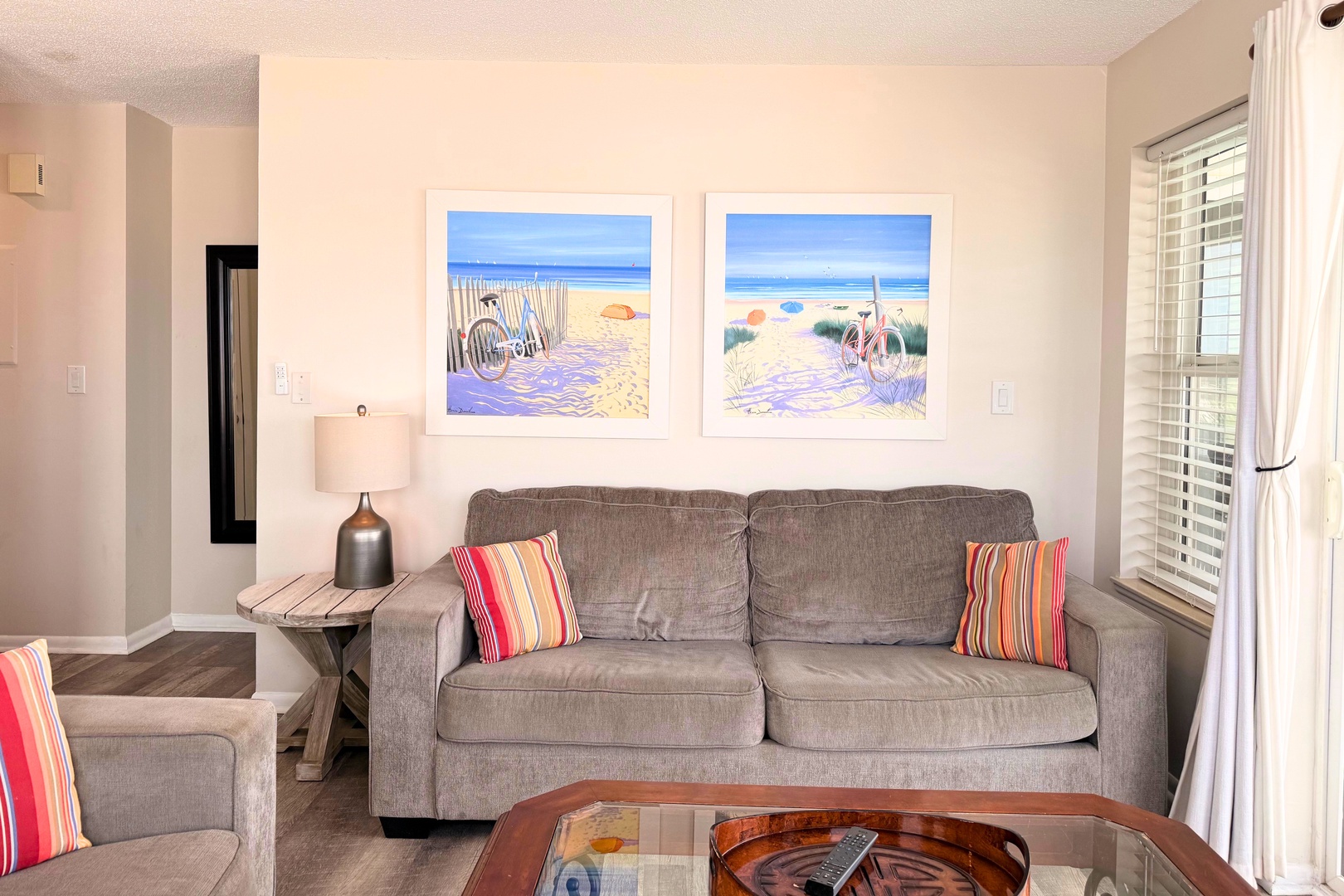 Settle into your cozy living space with plush seating and cheerful beach-inspired art that brings the ocean to you. The bright, airy room invites you to unwind after a day of exploring.