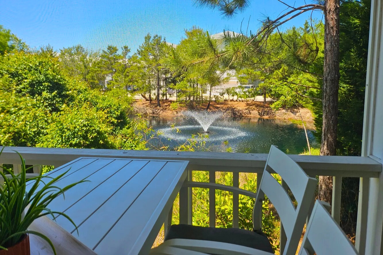 Unwind on the screened porch with peaceful pond views and gentle fountain sounds—perfect for morning coffee, casual meals, or relaxing after a sunny beach day.