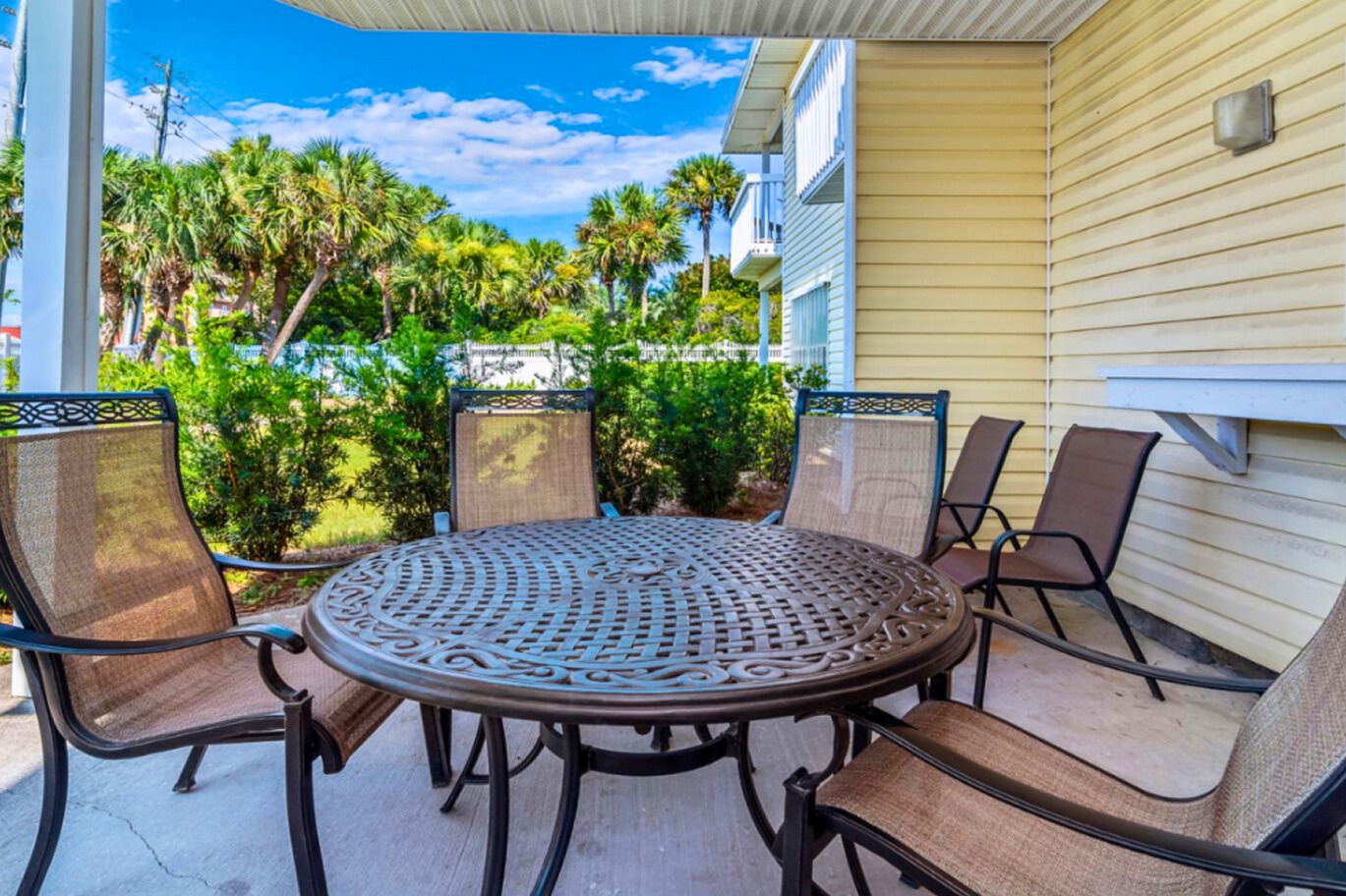 Your private outdoor dining space features a round table for six, perfect for morning coffee or sunset dinners overlooking lush tropical gardens.