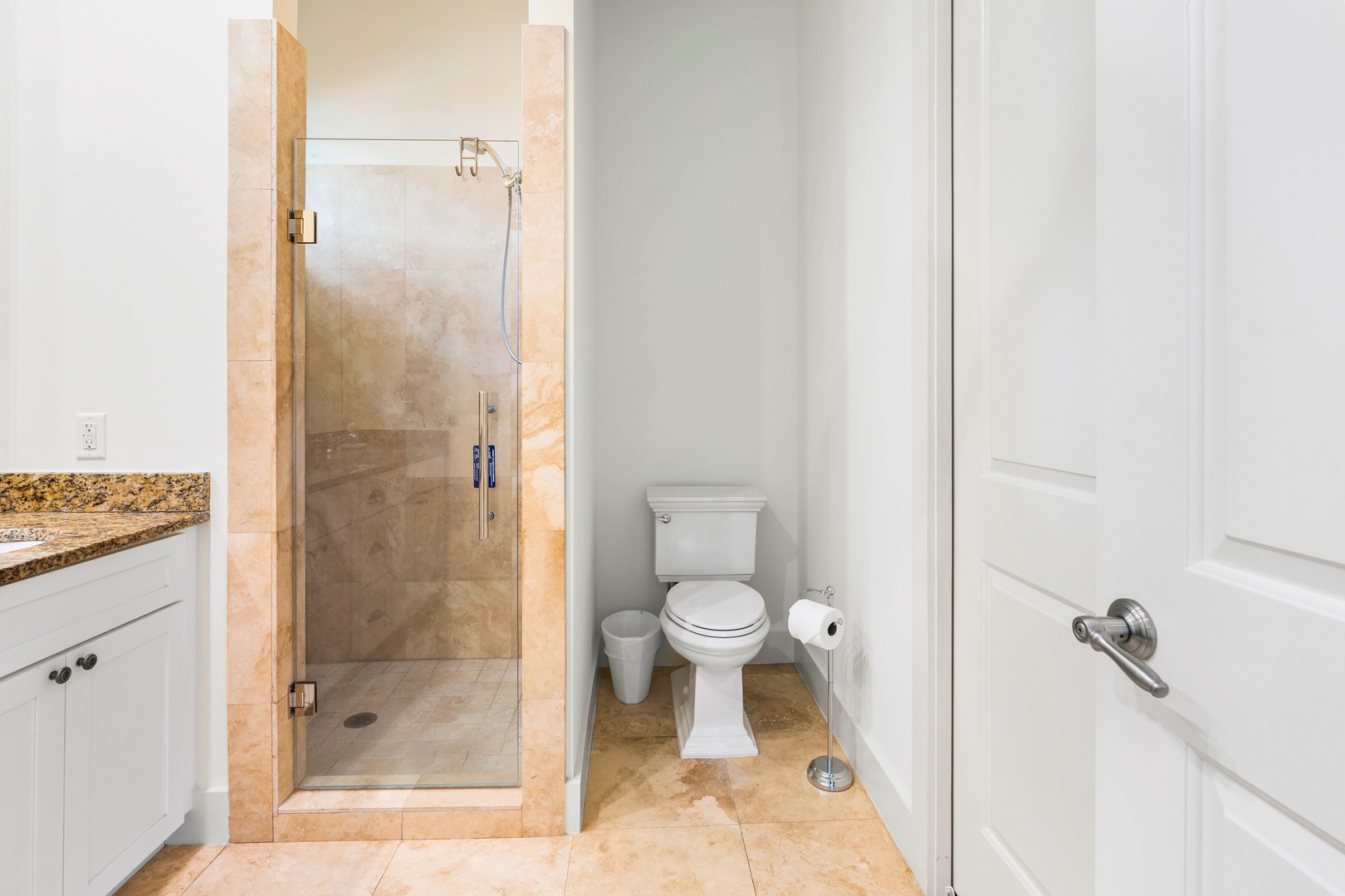 Step into your elegant bathroom featuring a spacious glass shower, granite countertops, and pristine fixtures that create your perfect morning routine.
