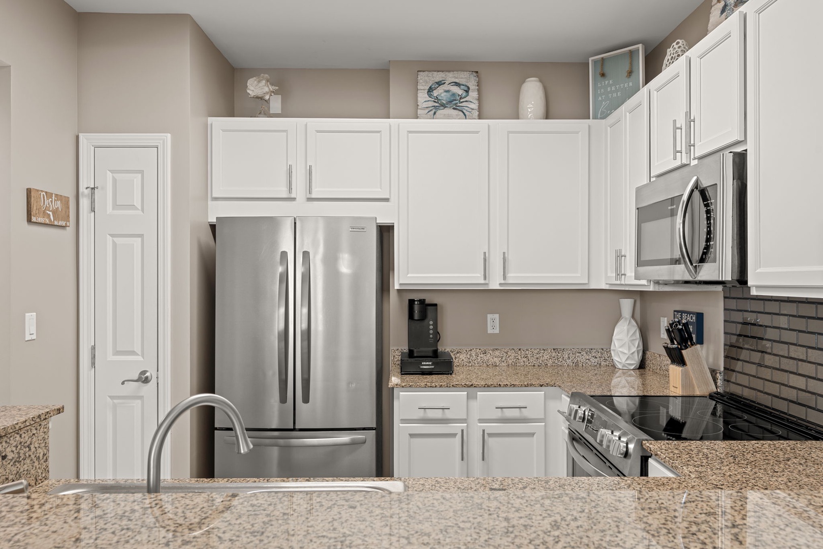 Your fully equipped kitchen features stainless steel appliances, granite countertops, and all the tools you need to prepare delicious meals during your stay. Coastal decor adds charm.