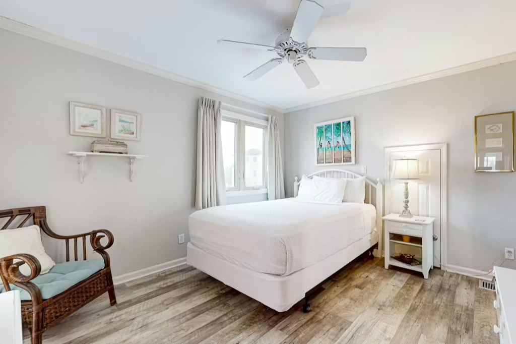 Sink into crisp white linens and drift off beneath the gentle ceiling fan. Wake refreshed in your serene coastal-inspired bedroom.