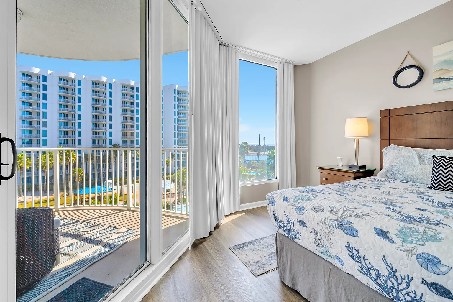 Wake up to stunning views from your bright bedroom, where floor-to-ceiling windows frame the cityscape and your private balcony awaits.