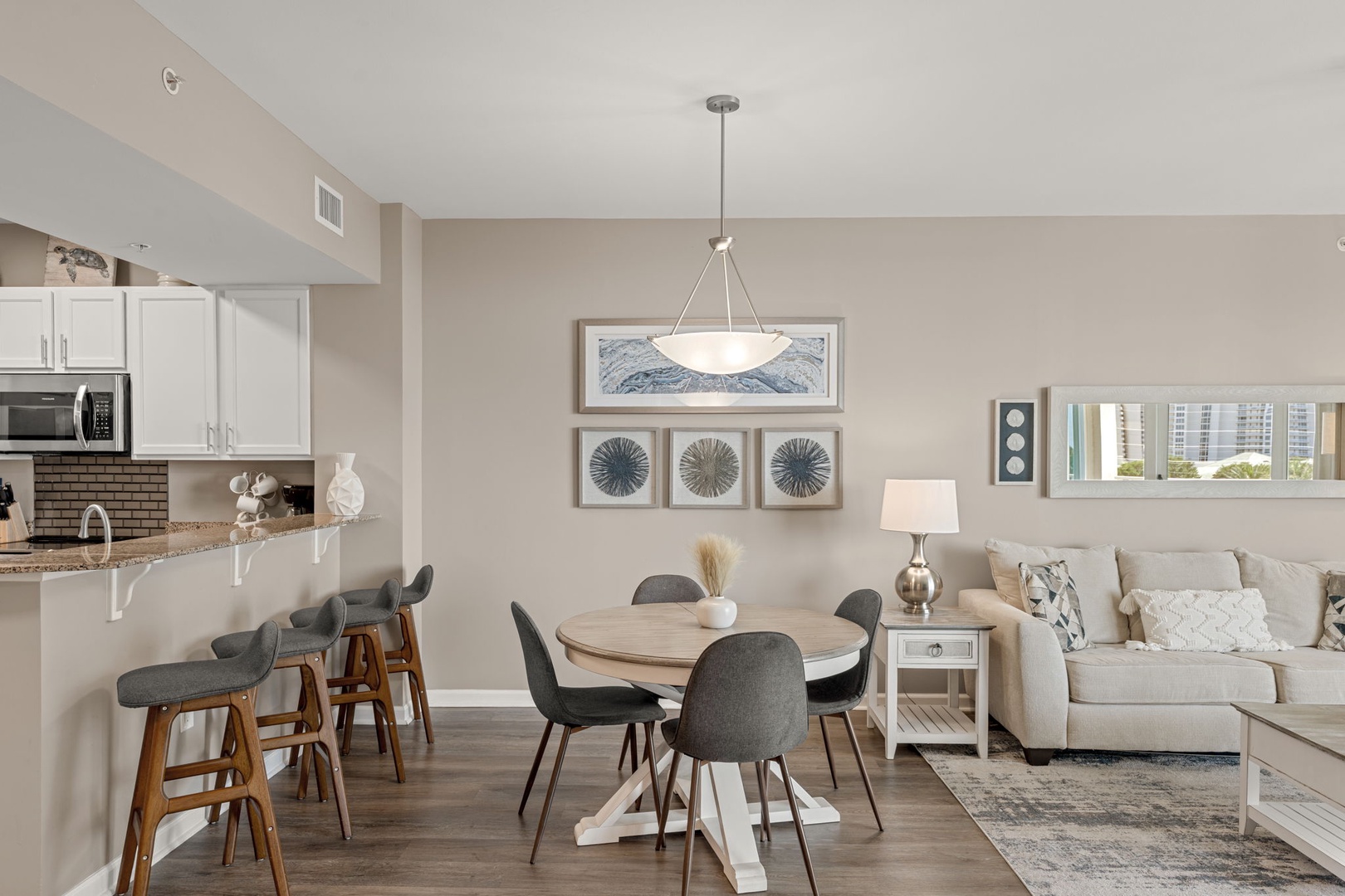 Picture yourself relaxing in this bright, open-concept space where modern design meets coastal comfort. The stylish dining and living areas flow seamlessly, inviting you to unwind after a day of adventure.