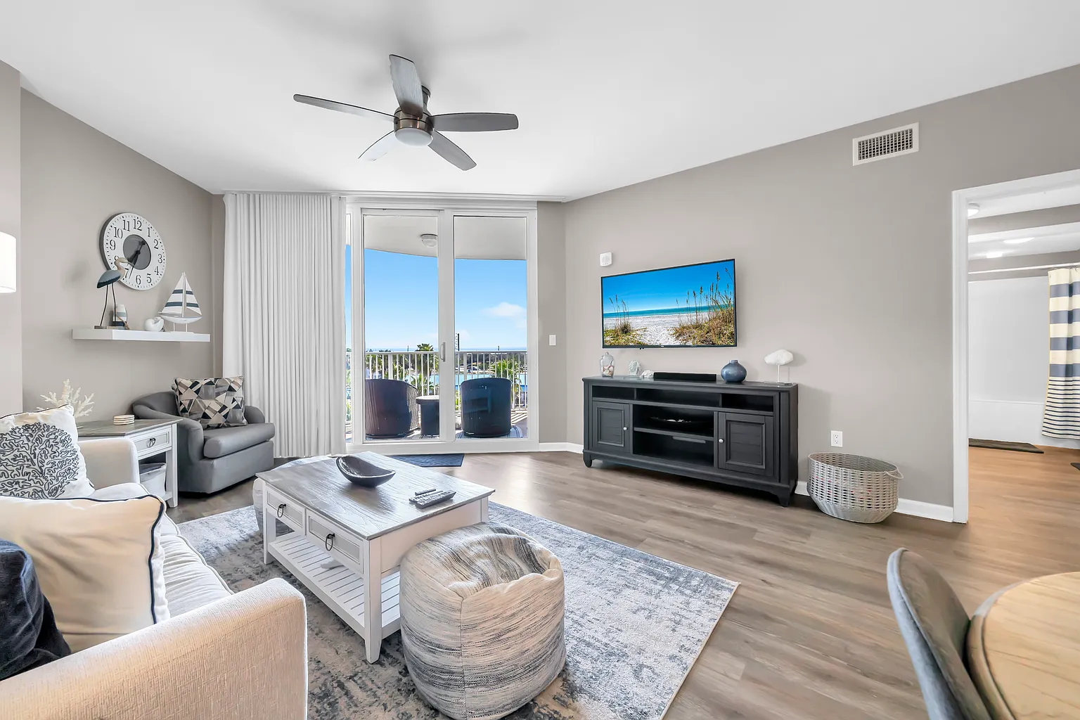 Relax in your stylish living room with coastal views from your private balcony. Modern comfort meets serene atmosphere for perfect getaway moments.