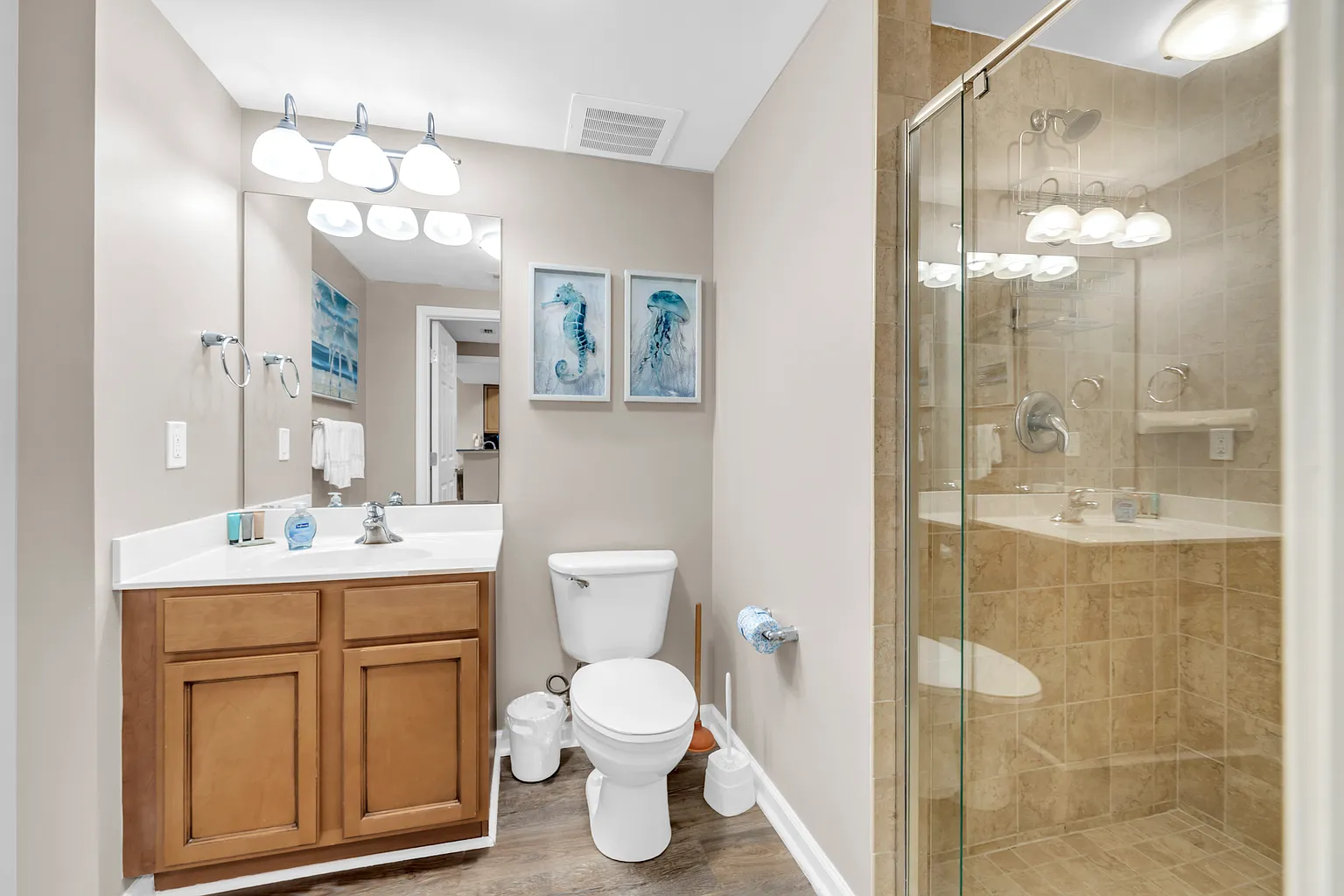 Unwind in your pristine bathroom featuring a luxurious glass-enclosed shower and elegant vanity with modern amenities for your comfort.
