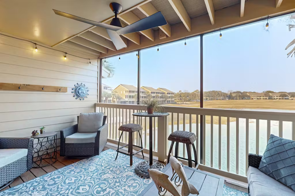 Sip your morning coffee on your private screened porch while soaking in peaceful lake and neighborhood views. The ceiling fan keeps you comfortable as you relax in this breezy coastal retreat.