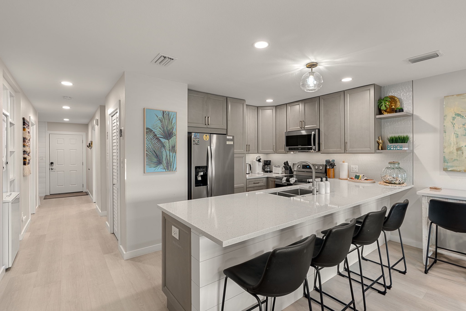 Gather around your spacious kitchen island with gleaming countertops and modern appliances, perfect for morning coffee or evening conversations with loved ones.