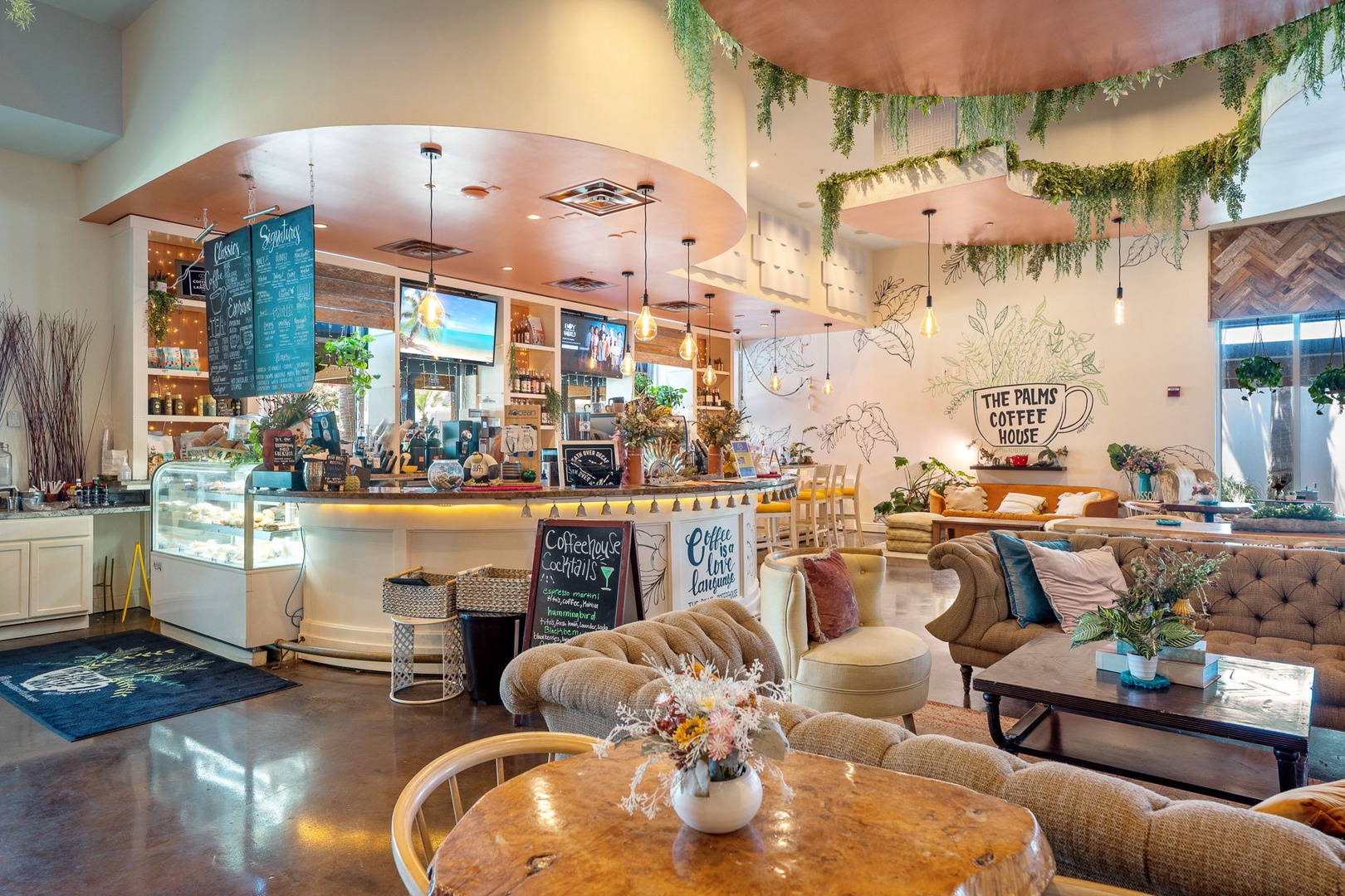 A stylish on-site café welcomes you with cozy seating, cascading greenery, warm lighting, and inviting spaces where you can relax with refreshments throughout your stay.