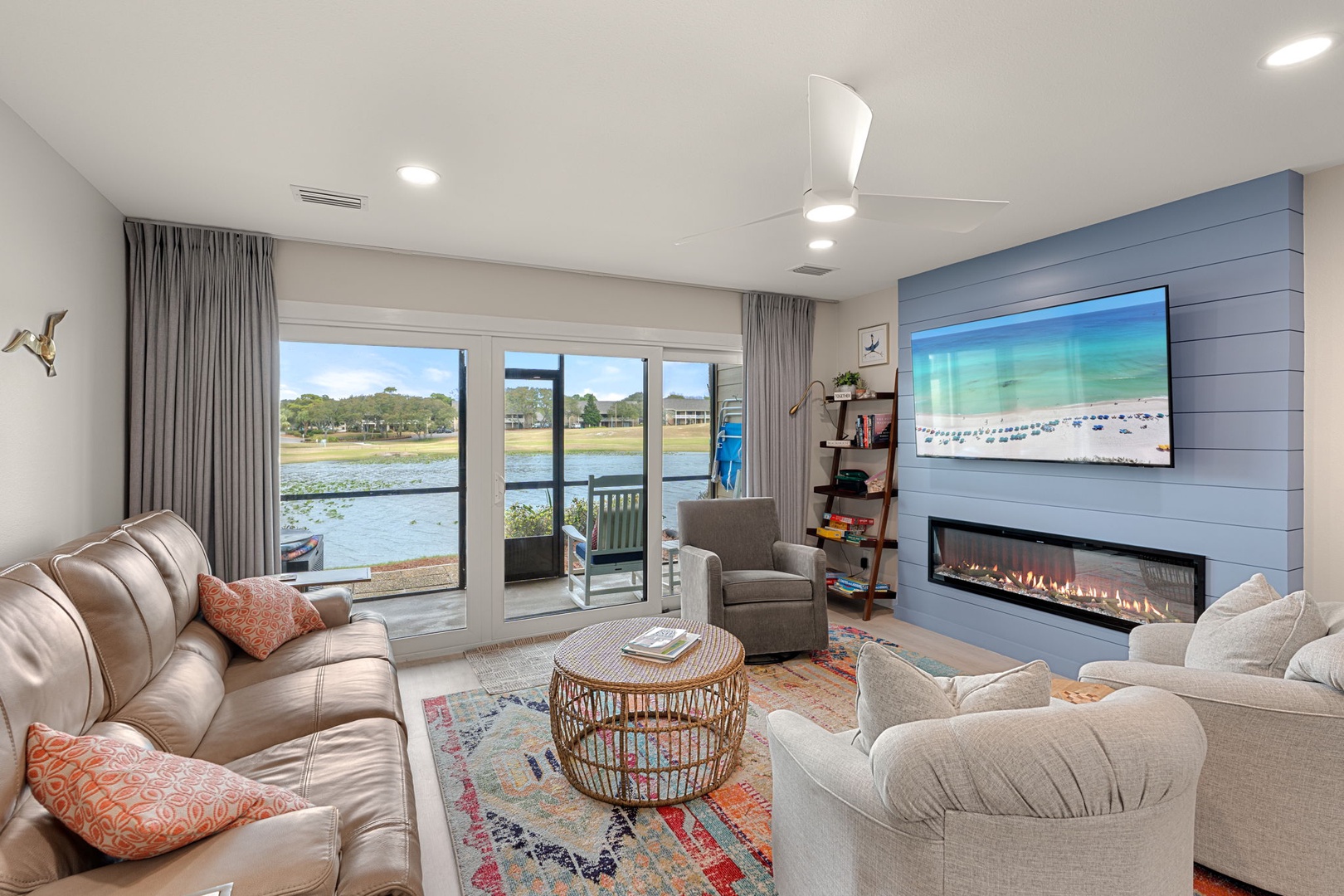 Unwind in your stylish living room with panoramic water views, cozy fireplace, and modern amenities for perfect relaxation.