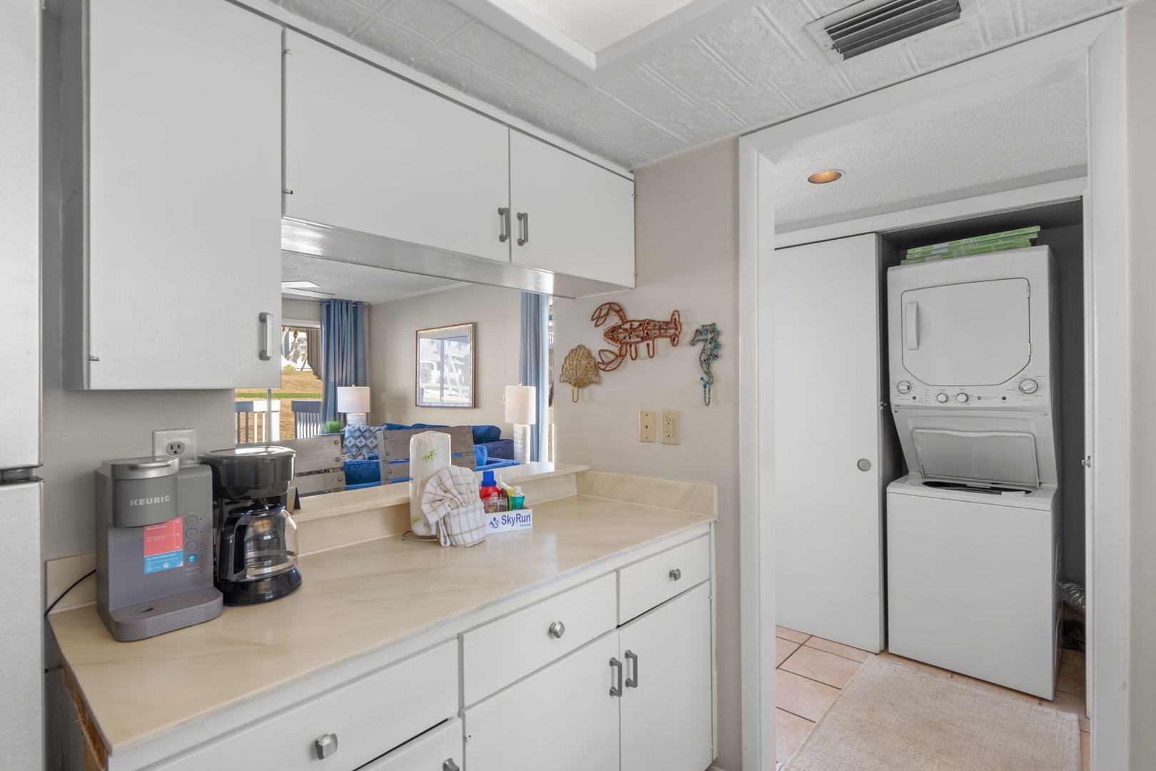 The kitchen offers ample cabinet space, a convenient coffee station, and an open layout that keeps everyone connected throughout the living and dining areas. A stacked washer and dryer are also included for added convenience during your stay.
