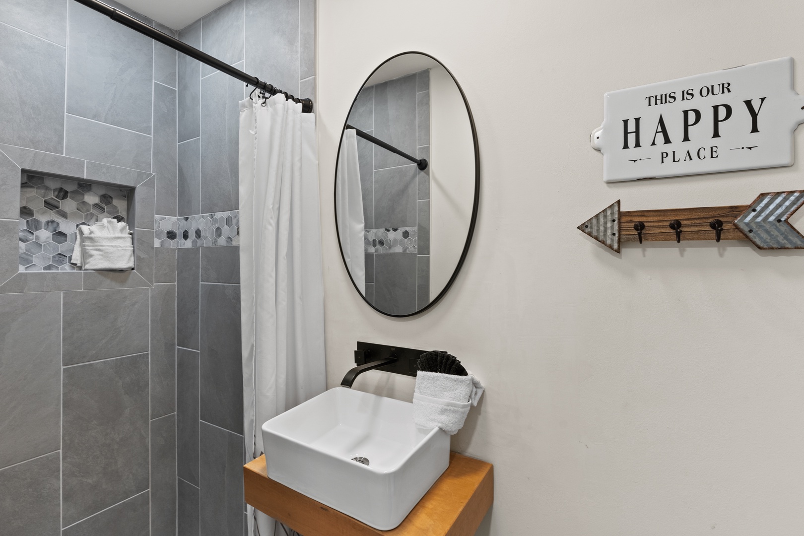 Refresh in your stylish bathroom featuring a modern vessel sink, spacious walk-in shower, and cheerful decor that makes every morning bright.