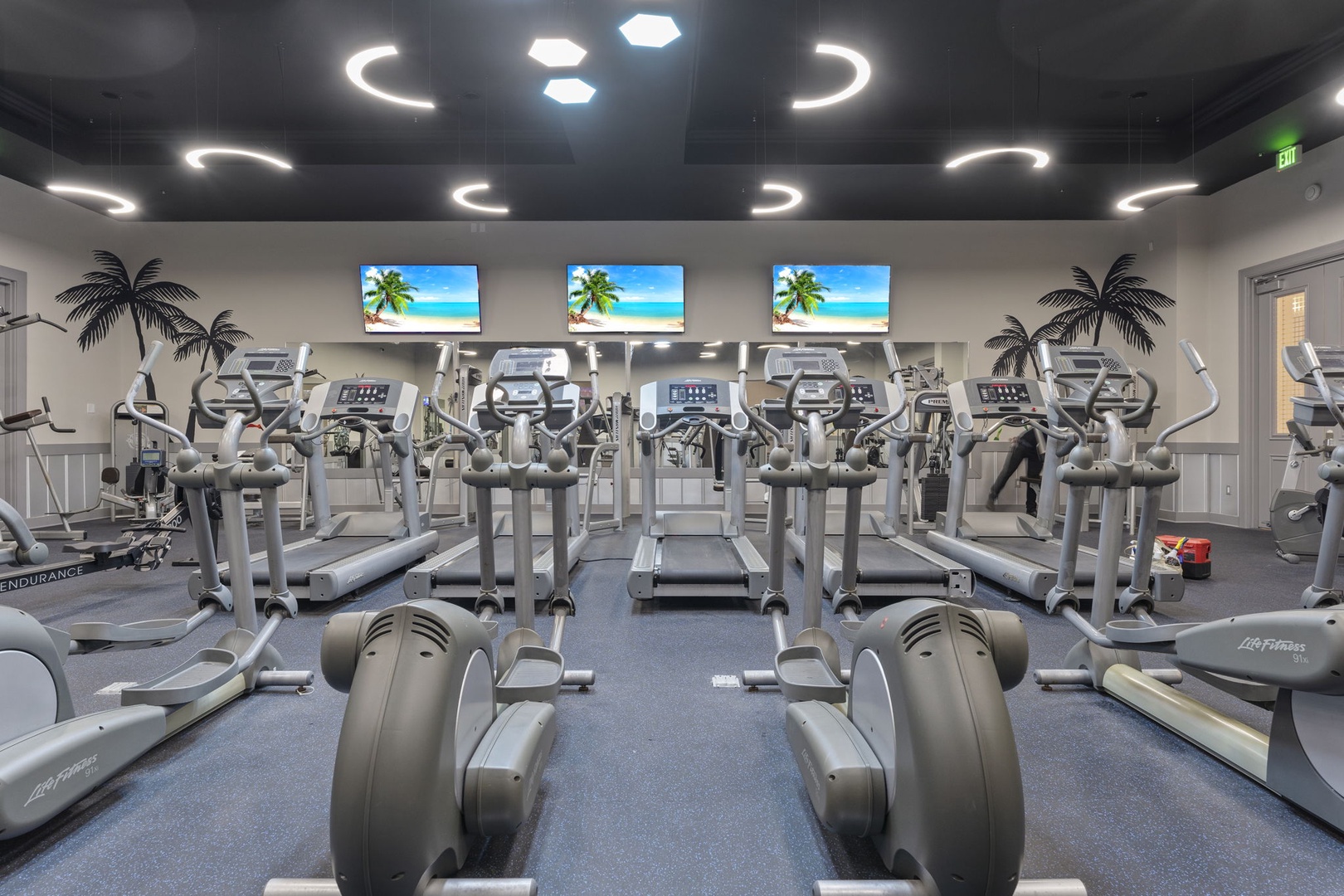 Stay active in your fully-equipped fitness center, where modern cardio and strength equipment awaits beneath tropical-themed decor and motivating ocean views on the screens.
