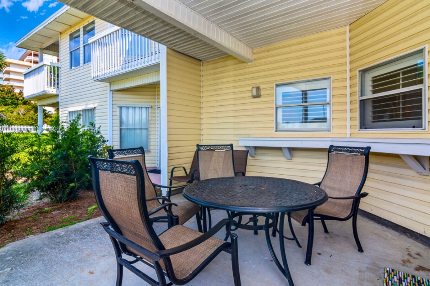 Enjoy morning coffee or evening meals on your private patio with comfortable seating for four, overlooking the peaceful garden.