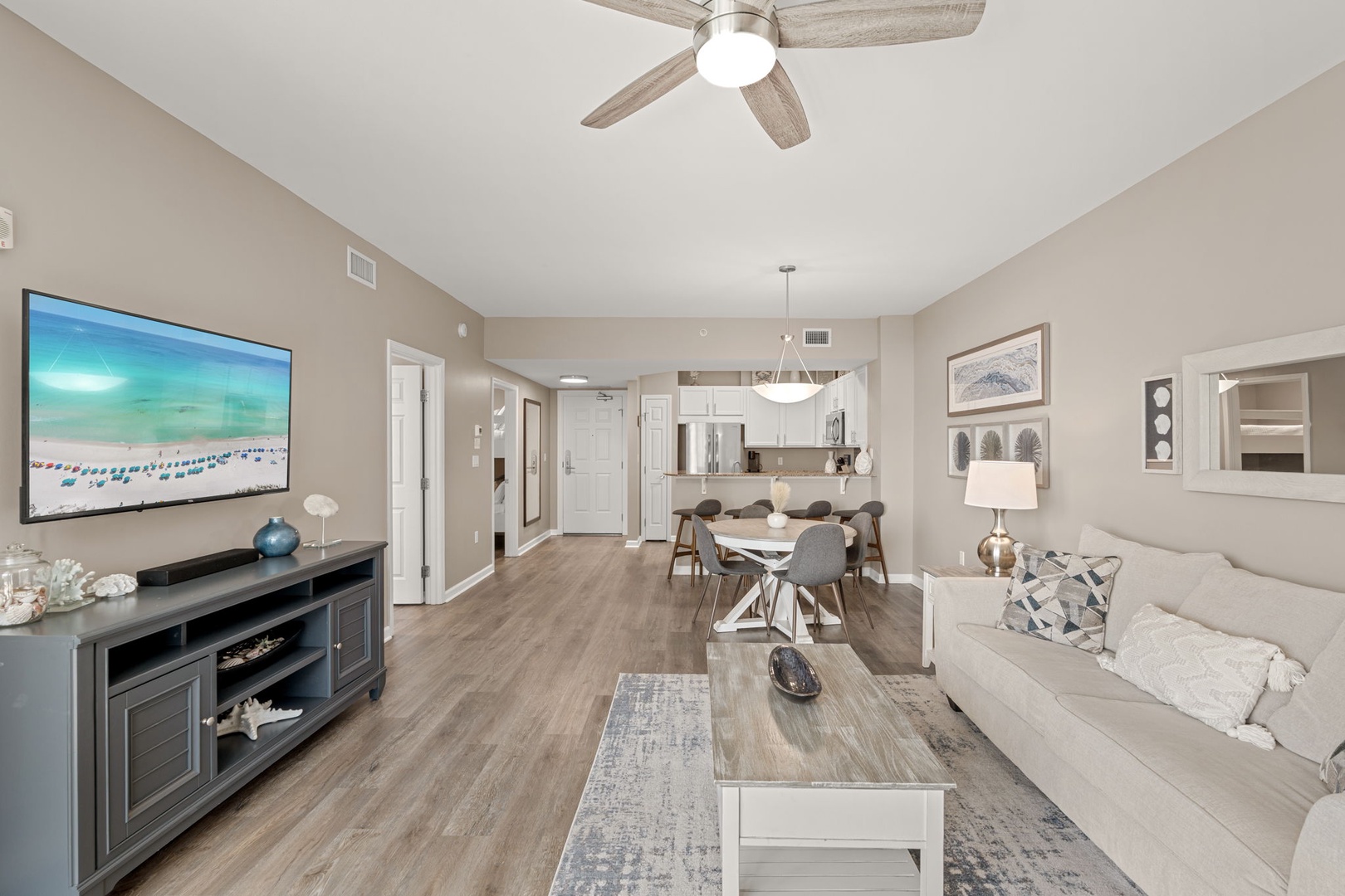 Relax in your open-concept living space with modern comforts—settle into the plush sofa, enjoy your favorite shows on the large TV, and gather at the dining table for memorable meals together.
