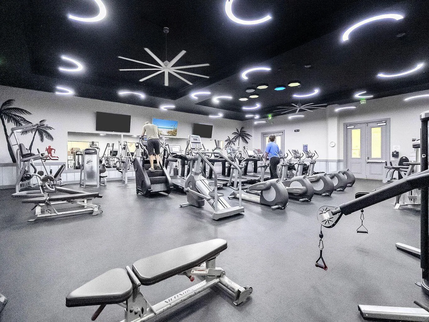 Stay fit during your getaway in this spacious fitness center, featuring modern cardio machines, strength equipment, and tropical-themed décor to keep you motivated.