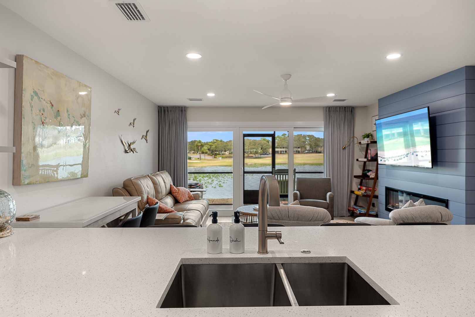 Your open kitchen flows seamlessly into a bright living space where you can cook while enjoying waterfront views and cozy fireplace moments.