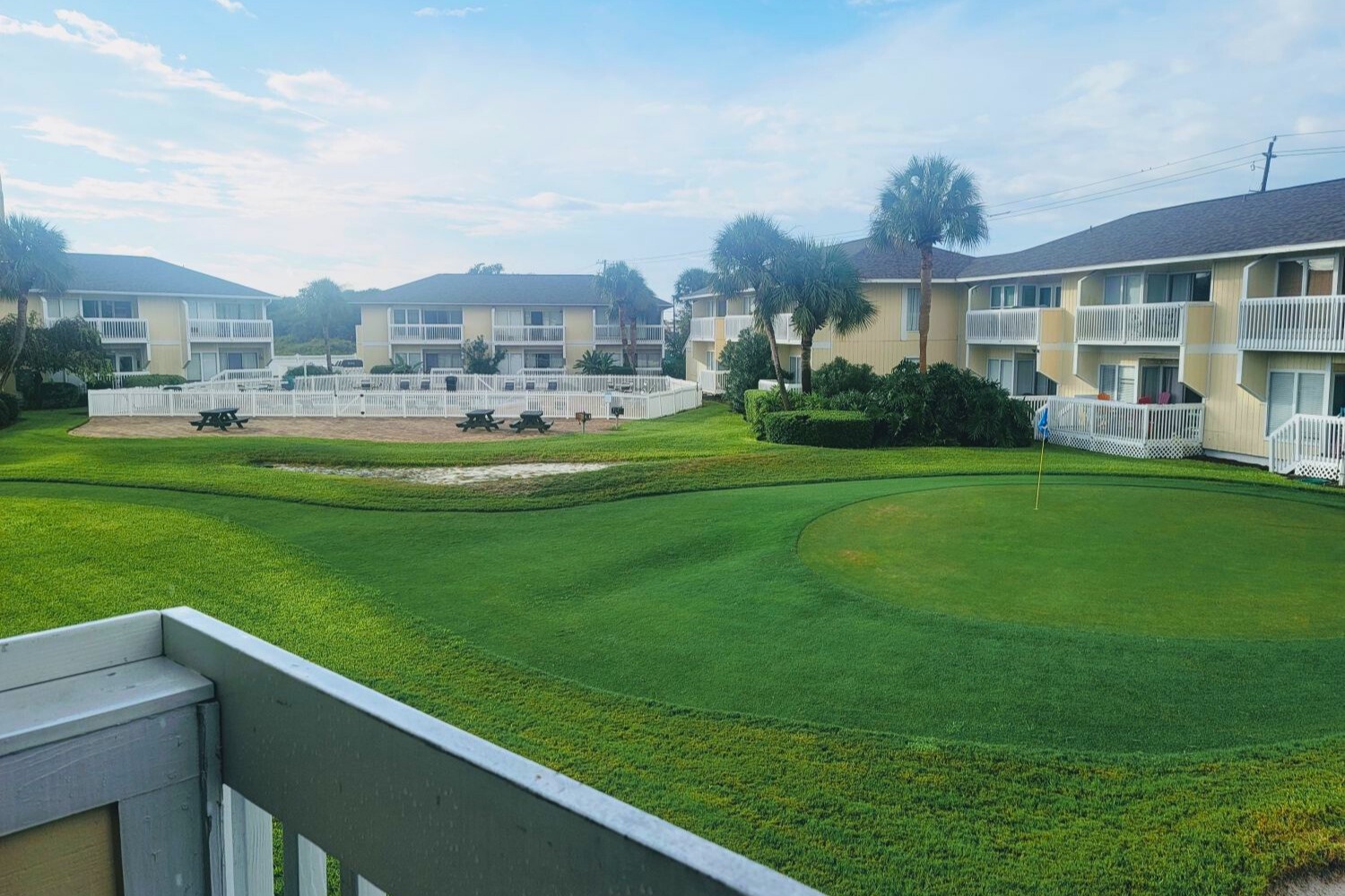 Wake up to stunning golf course views from your private balcony, with perfectly manicured greens stretching toward palm-lined grounds.
