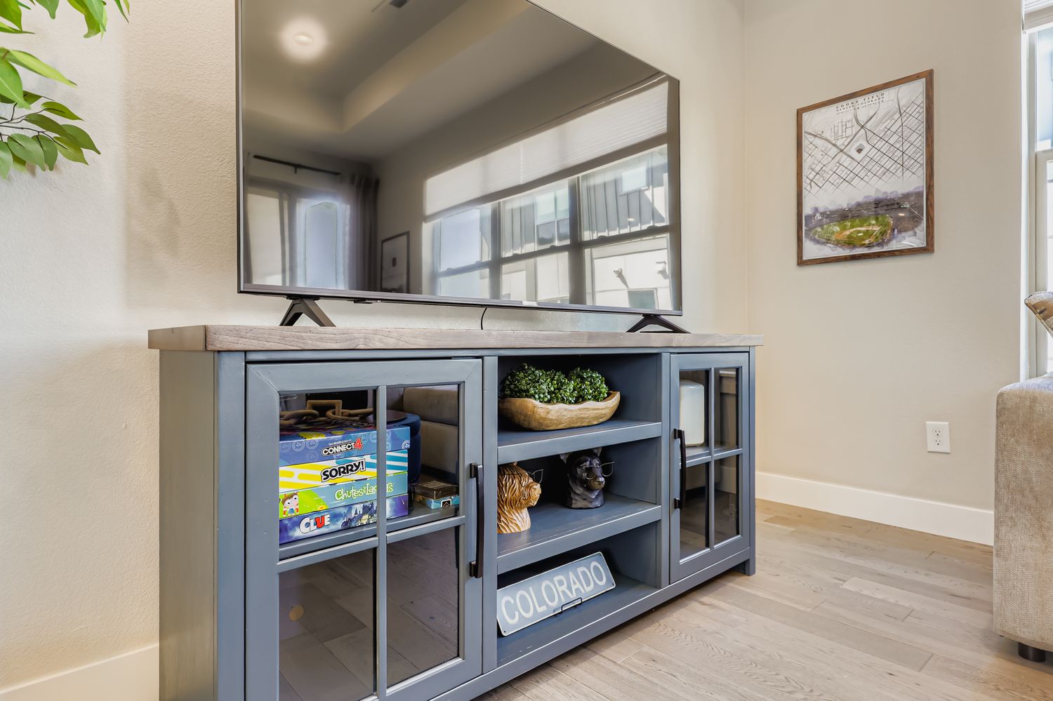 Your stylish living area features a custom entertainment center with ample storage for games and personal items, plus a mounted TV for cozy evenings.