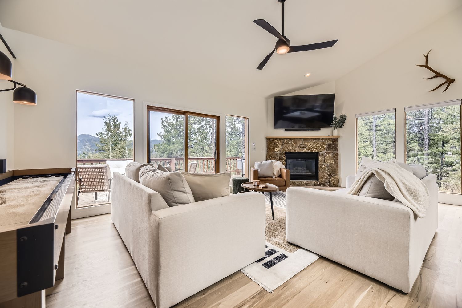 Sink into plush sofas while mountain views fill every window and your stone fireplace crackles warmly nearby.