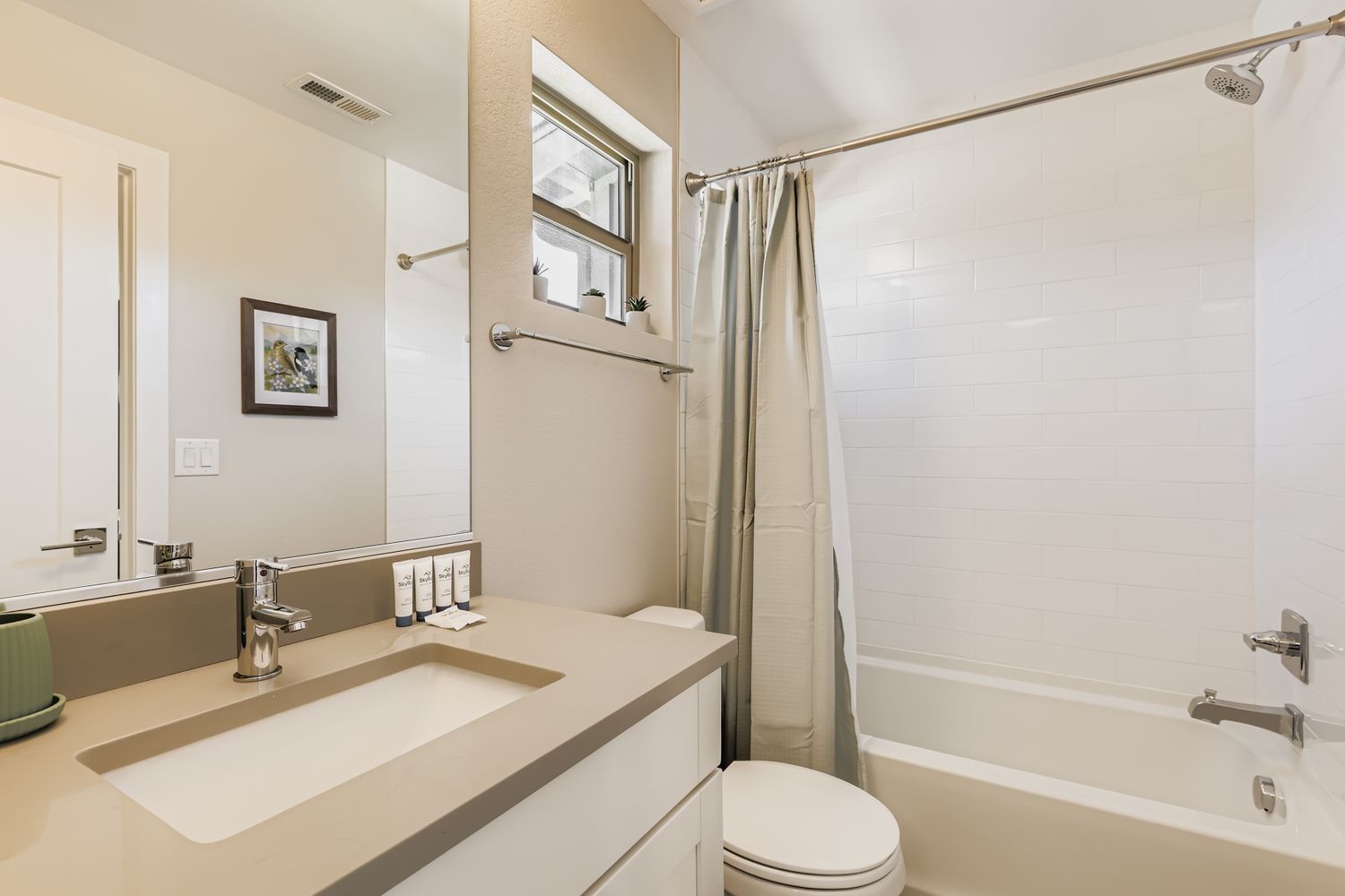 Your sleek bathroom features modern fixtures, a relaxing tub-shower combo, and thoughtful amenities to refresh after your adventures.